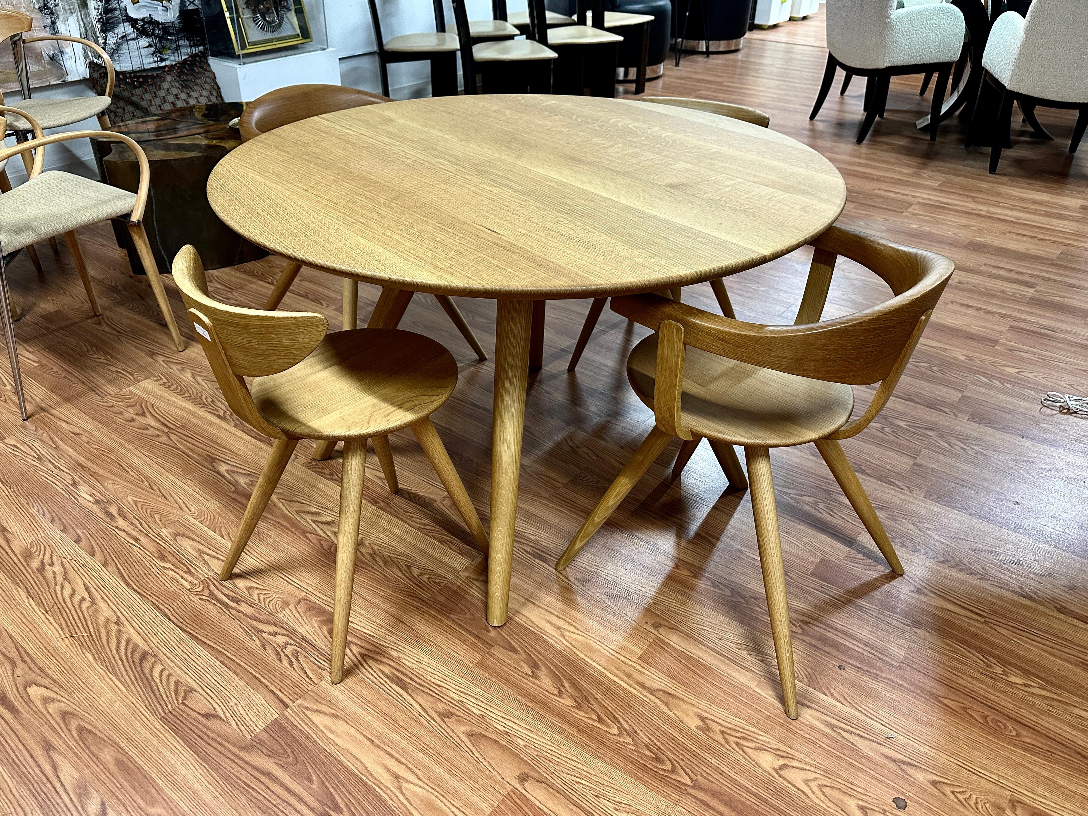 A beautiful dining table and chairs by Sori Yanaga Design for Hida of Japan. This wonderful set in oak consists of 2 armchairs, 2 side chairs and the 47 inch diameter table.
While he died in 2011 his design studio is still producing his designs with