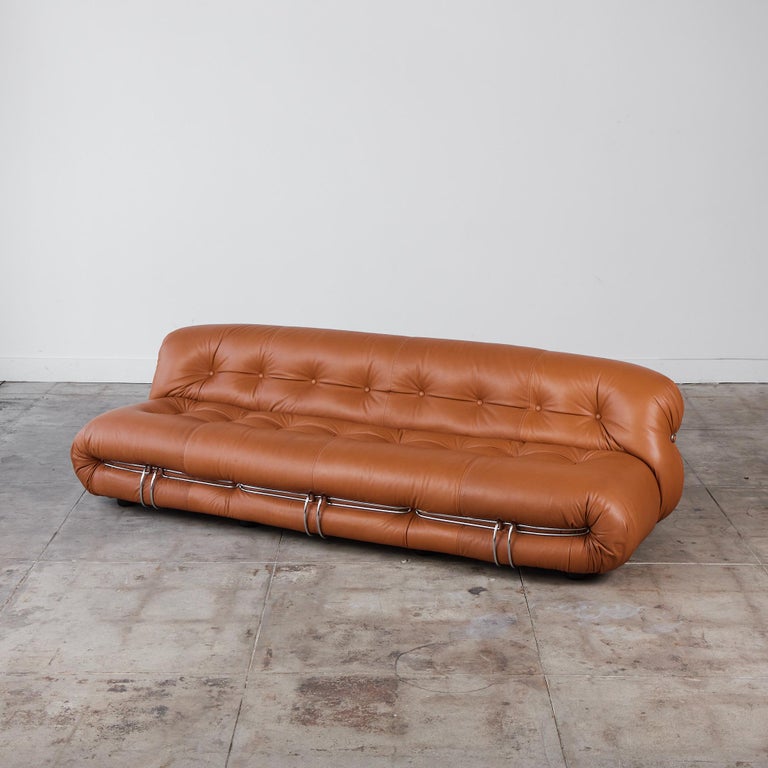 Designed by Italian husband and wife duo, Afra and Tobia Scarpa, the Soriana sofa boasts comfort. Made in the 1970's for Cassina, this sofa rounded body showcases a beautiful gathered camel colored leather with tufting at the backrest and seat. This
