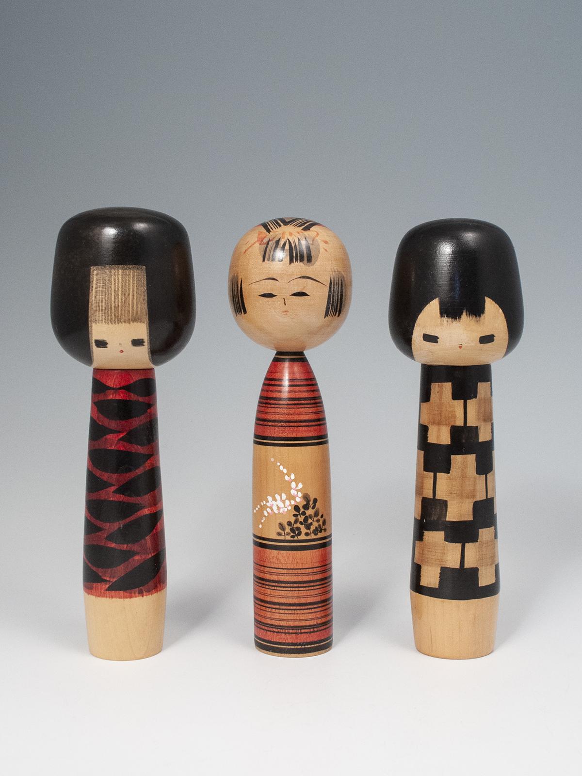 Sosaku Kokeshi dolls by Hideo Ishihara and Kichisuke Agatsuma, Japan

Two of these vintage creative kokeshi were made and signed by the award winning master, Hideo Ishihara (1929-1999). The kokeshi in the center was made and signed by Kichisuke