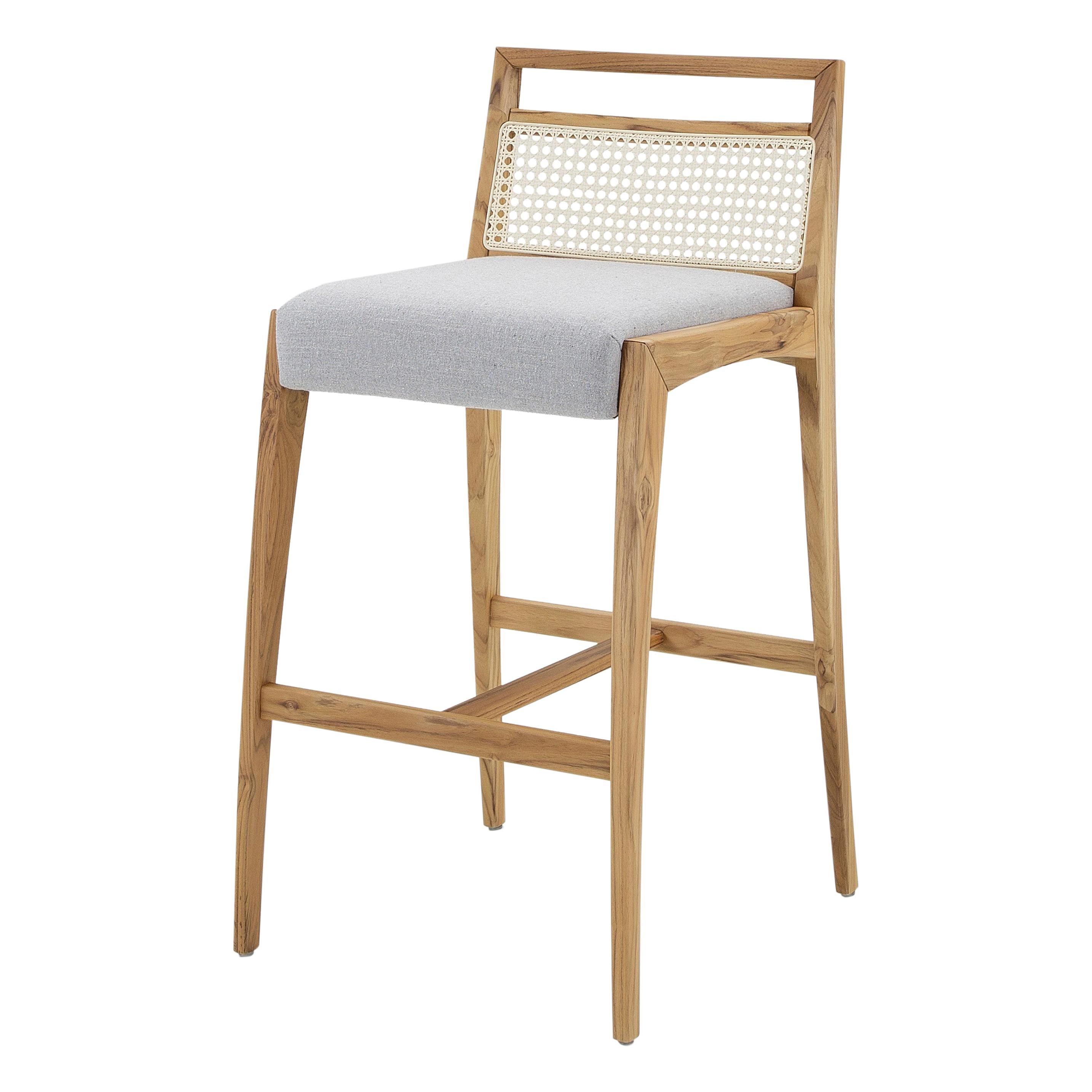 The Sotto counter stool is a piece that is designed with a taller high to use at a countertop or a high table. This chair has striking features, where resistance and delicacy meet. Designed with a teak finish wood legs and frame, a gray fabric