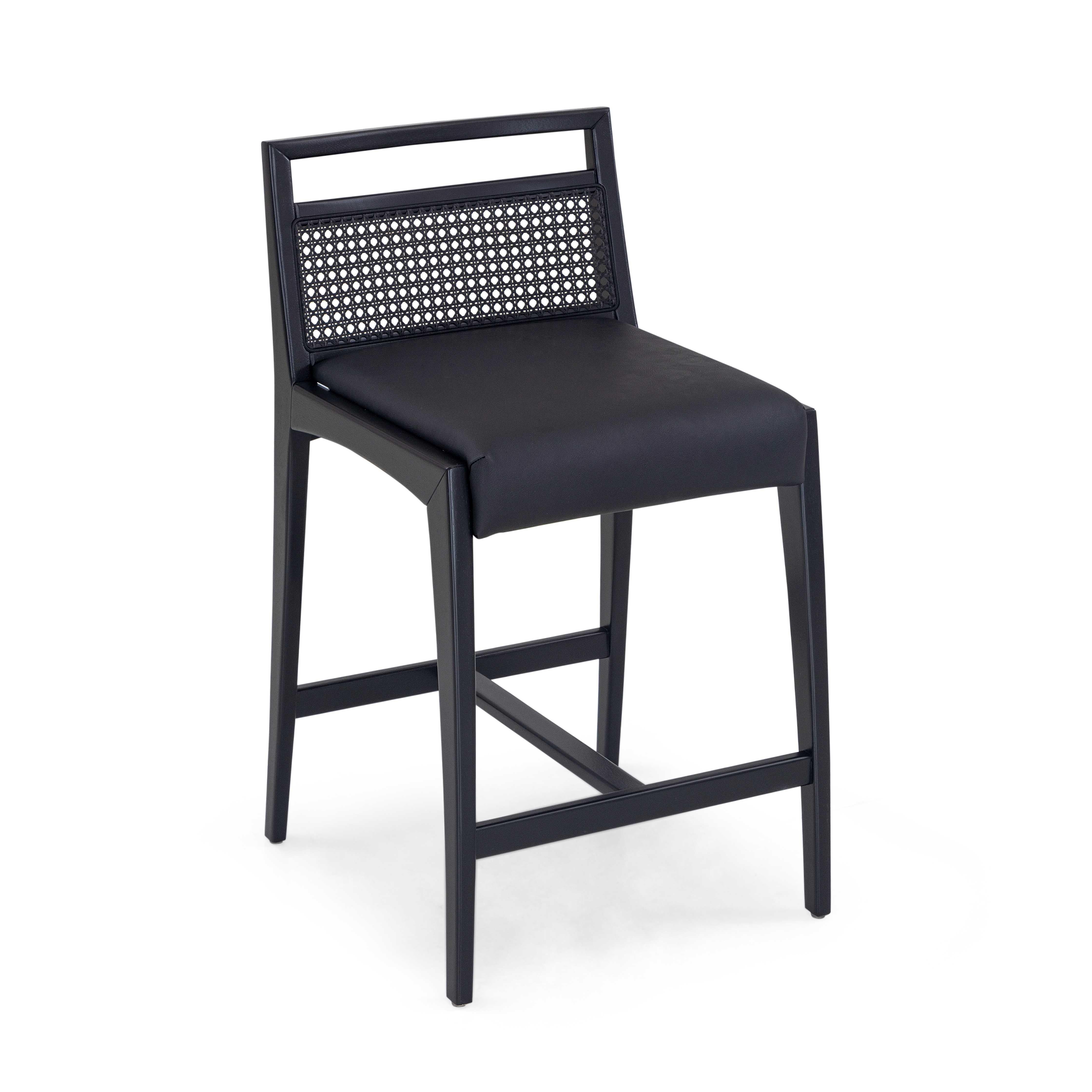 A Sotto counter stool designed by Uultis Studio with black matte finish. The Sotto counter stool exudes a sleek and modern aesthetic, making it a versatile addition to both contemporary and traditional interiors. Its black matte-finished frame is
