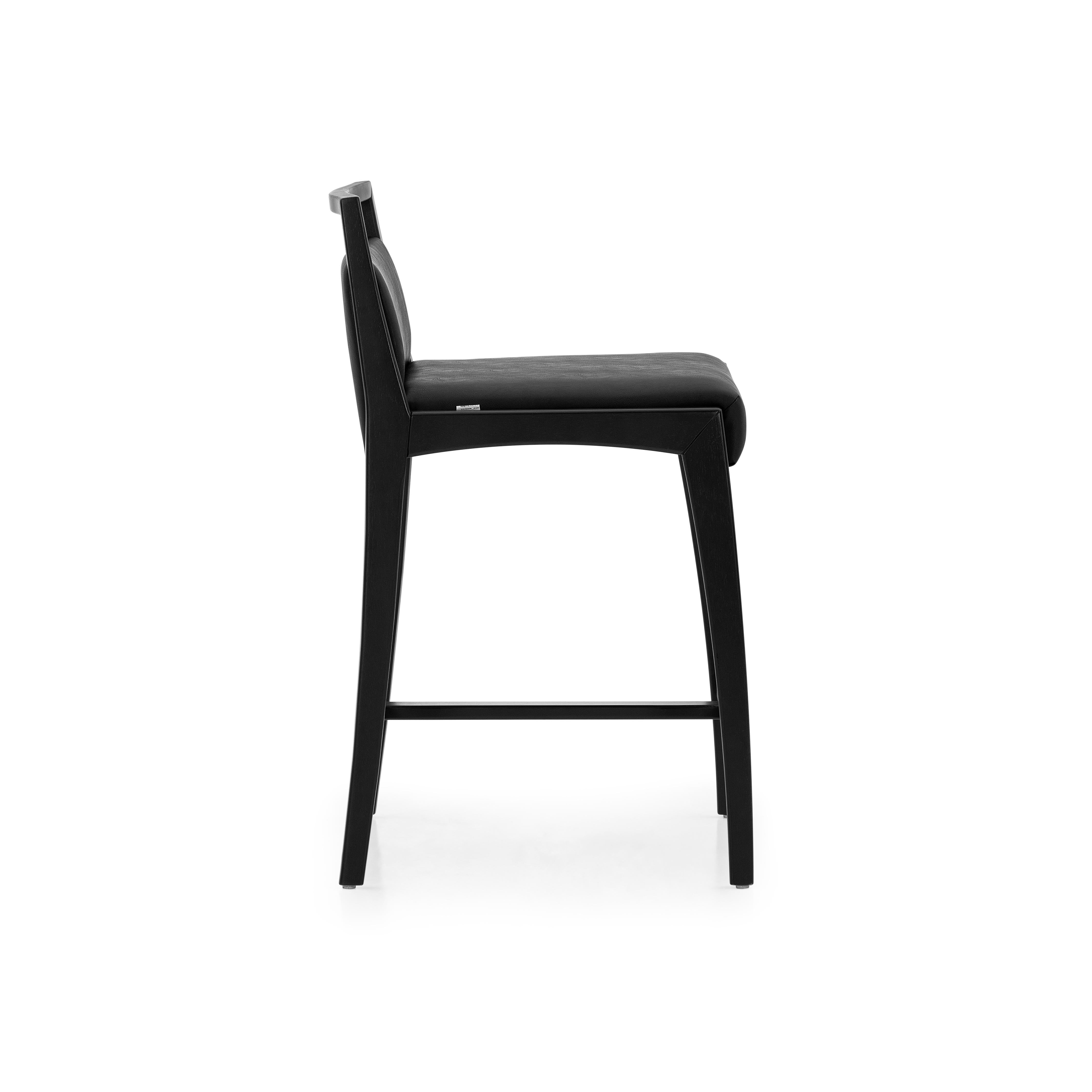 The Sotto counter stool is a piece that is designed with a taller high to use at a countertop or a high table. This chair has striking features, where resistance and delicacy meet. Designed with black finish wood legs and frame, a black faux leather