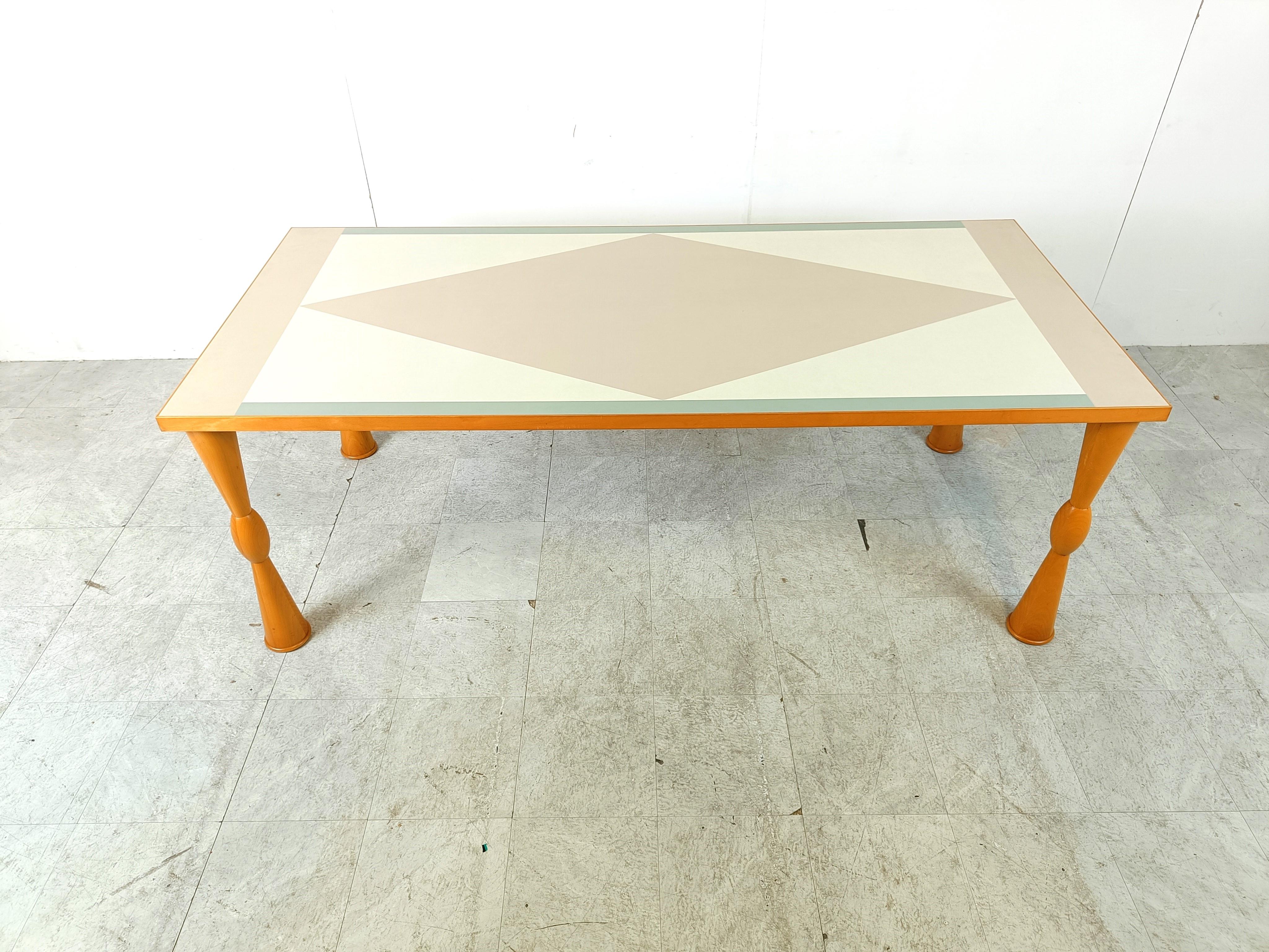 Postmodern dining table designed by Ettore Sottsass for Zanotta Italy.

Attractive and payful 'memphis' design.

Made of beech wood and a laminated geometrical table top.

1990s - italy

Legs can be rmeoved for shipping.

Height: 74cm/29.13