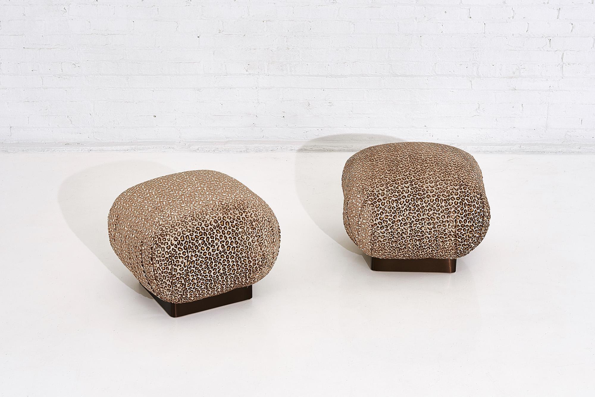 Pair of Soufflé pouf ottomans, stools on bronze bases with leopard upholstery.