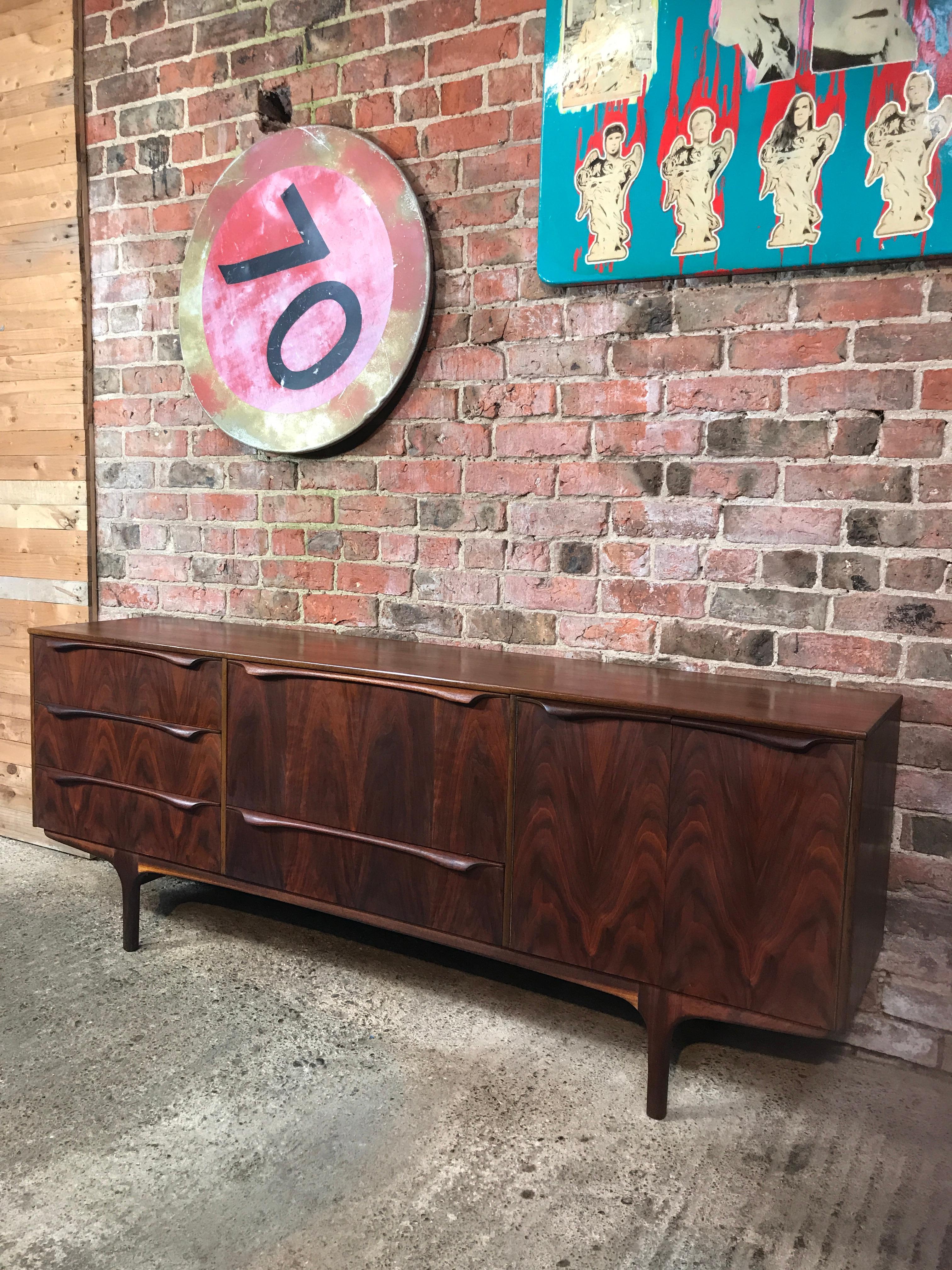 Sought After black walnut 1950 Sutcliffe Retro vintage sideboard
Lots of storage space, it has 4 drawers one with a removable cuttlery drawer, cocktail cabinet and a large cupboard, it stands on solid teak legs.

Super condition, one of the best
