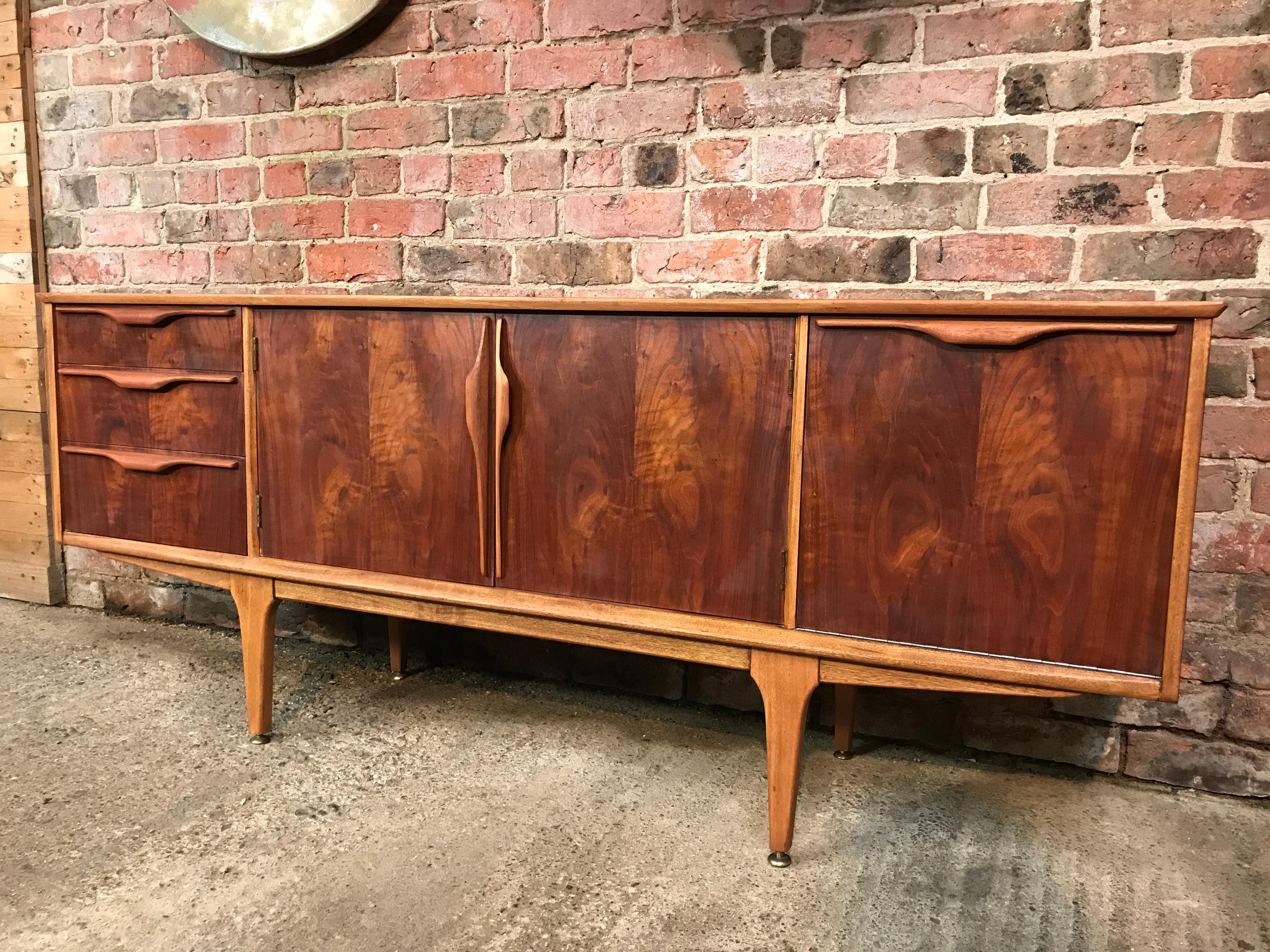 Sought after Vintage 1960 very rare walnut Jentique retro sideboard / credenza, it has three drawers on Left and lots of cupboard space, it stands on lovely solid teak legs.

Measures: Height 74cm, depth 45cm, width 183cm.