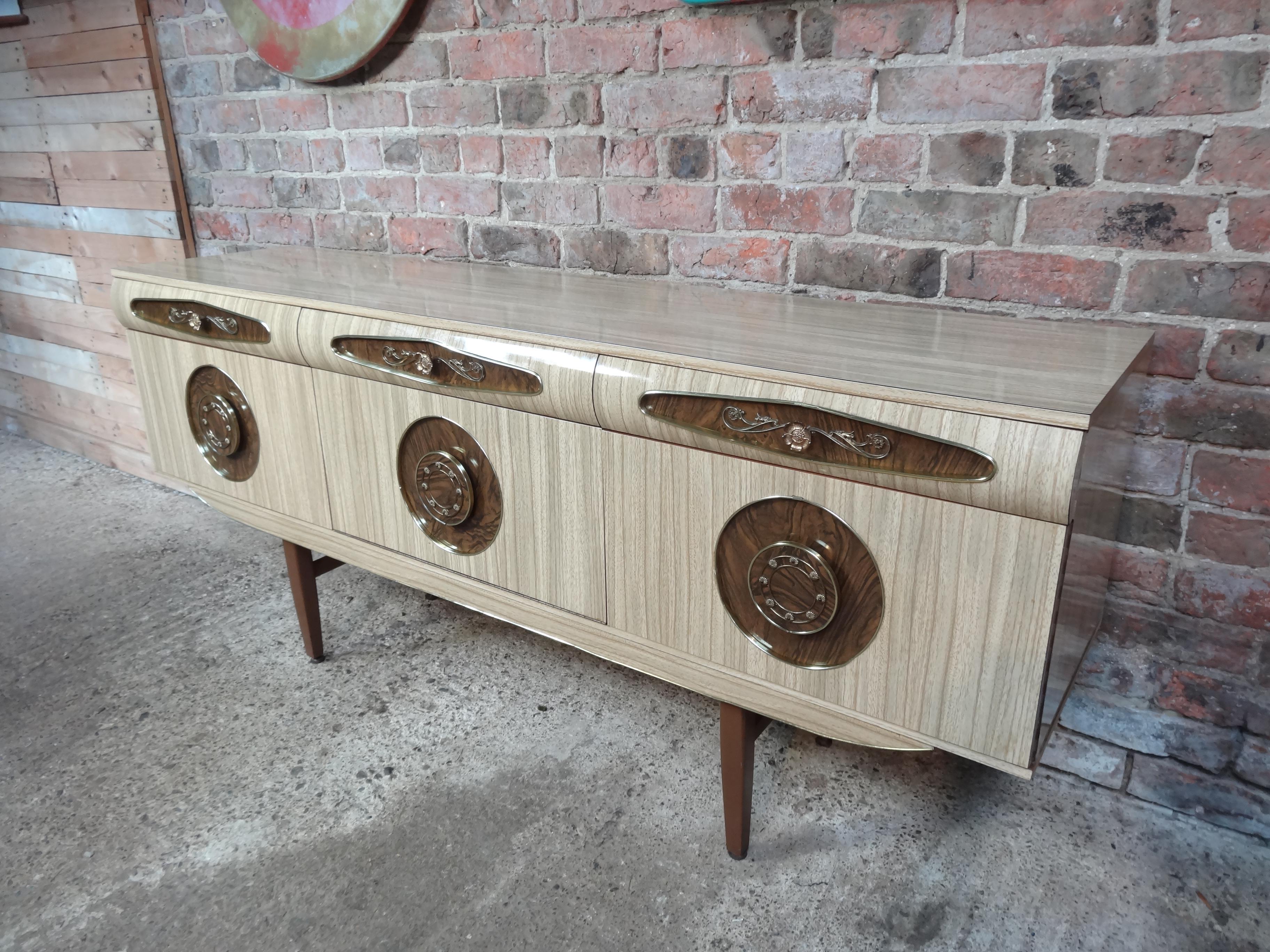 Sought after vintage retro Italian melamine sideboard with brass handles its from early 1950s. It has three drawers, cupboard space with lovely brass handles. Credenza is in very good original condition.