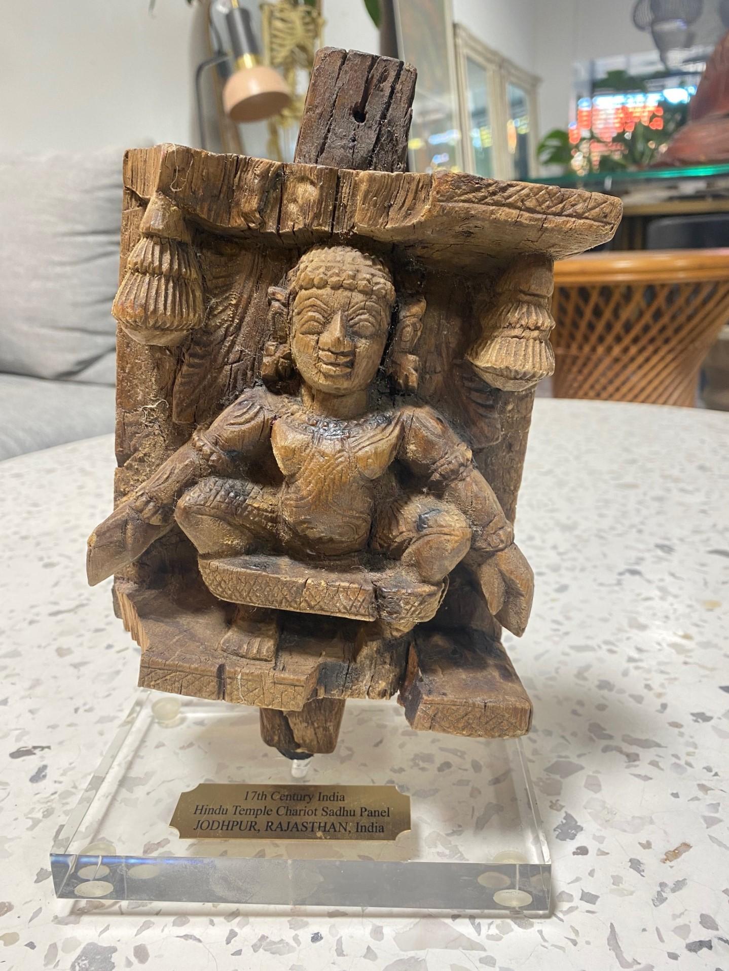 A wonderful Indian (South India) wood-carved Hindu temple chariot Sadhu panel deity sculpture from Jodhpur, Rajasthan, circa the 17th century (as marked on base).  

This piece is hand-carved from a single piece of wood and has a dark, rich patina