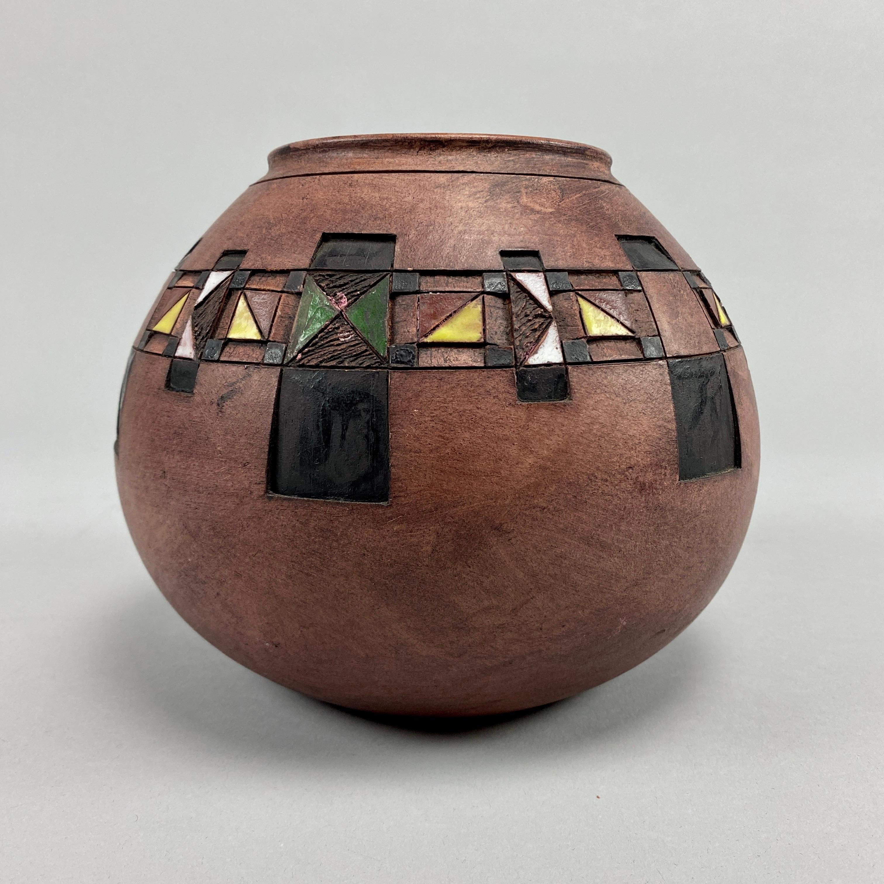 Step into a world of cultural fusion and artistic expression with the exquisite collection of three hand-made clay pots from 2006, crafted by Afrikania. These captivating pieces seamlessly blend the rich traditions of two distinct cultures,