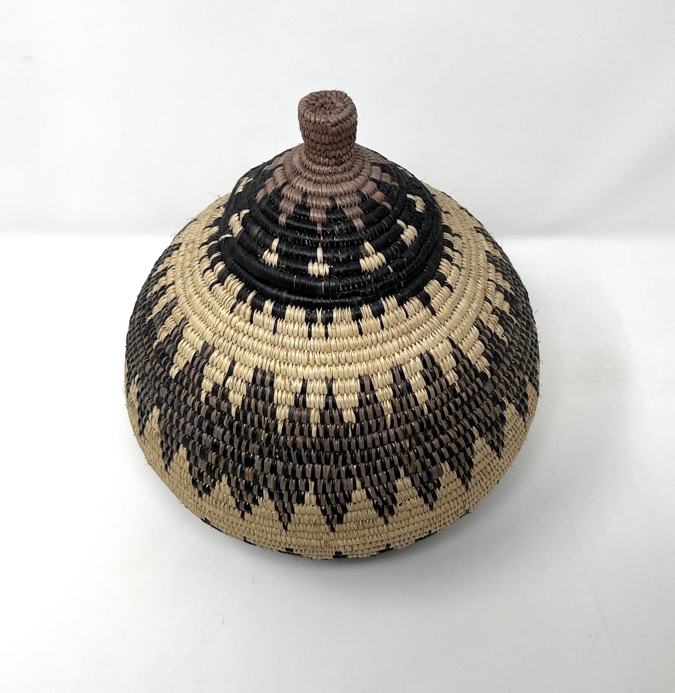 This basket is made of natural elements and traditional fibers sourced from nature and assembled together by skilled weavers, using the extract of dyes obtained from natural sources like roots, barks, fruit and berries, and leaves. Black, tan and