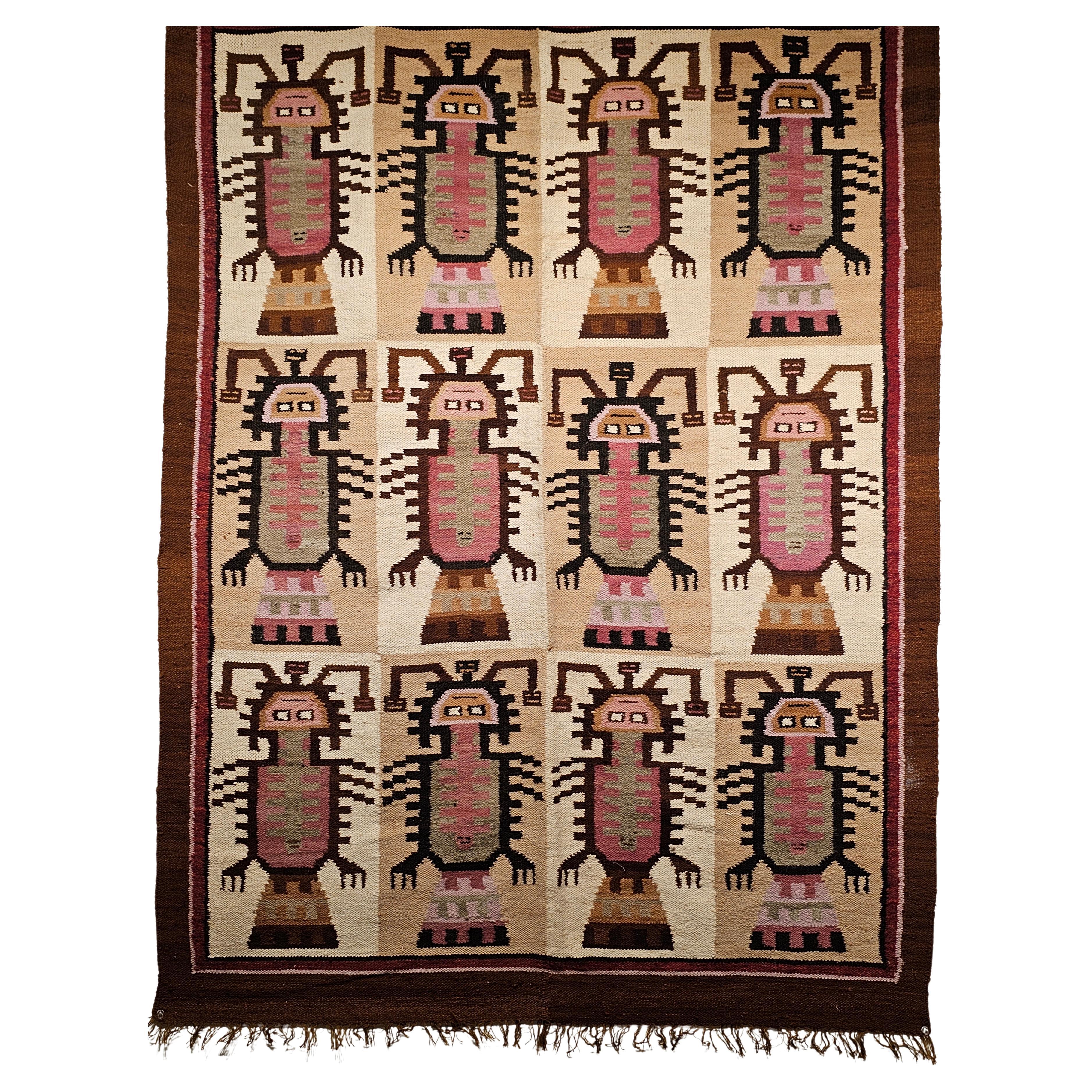 Vintage South American pictorial rug in deity forms pattern in ivory, brown, purple, and pink colors circa the 3rd quarter of the 1900s.  . The tapestry has a beautiful design of repeated deity forms in various pastel colors.  Although the figure