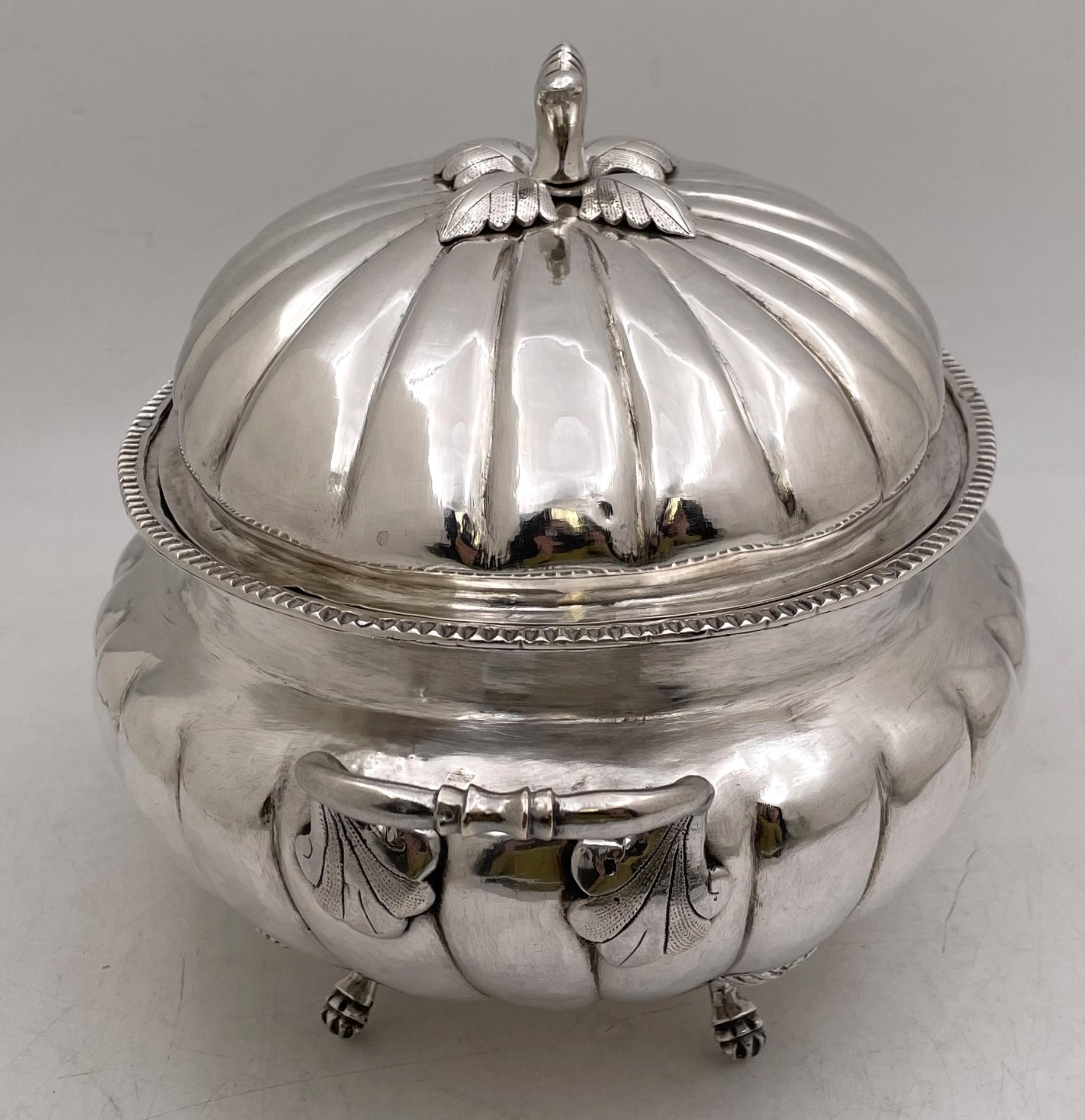 South America, probably Peruvian, silver tureen with its cover, from the 19th century, hand chased and in ovoid form, standing on 4 pawed feet, and exhibiting a finial with natural motifs. It measures 8 1/2'' in height with the lid (5 1/2'' without)