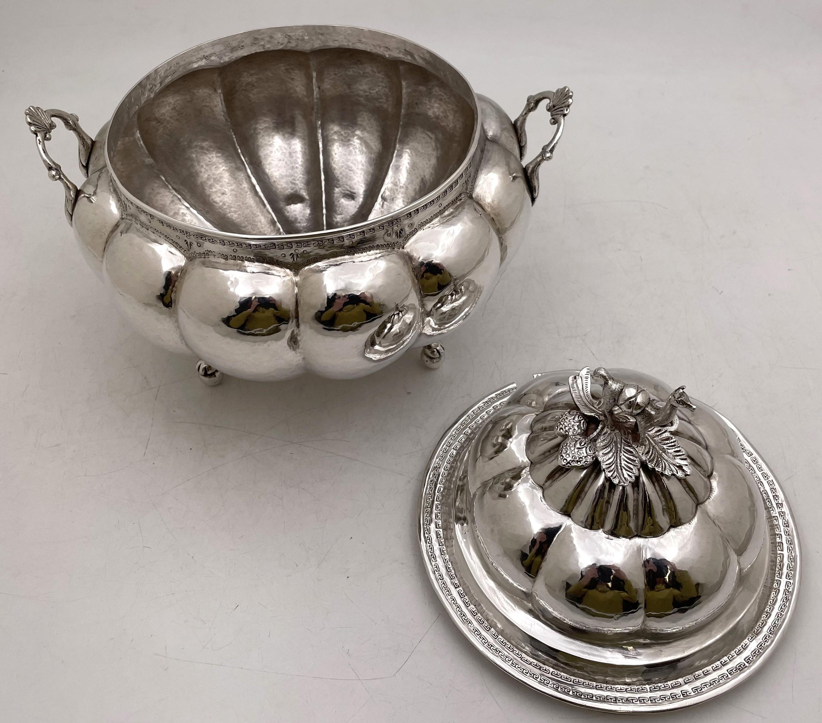 Latin American, probably Peruvian, silver tureen with a cover, from the 19th century, hand chased, in a circular shape, standing on 3 paw and ball feet, and with a camel finial. It measures 10 3/4'' in height with the lid (6'' without) by 10'' in