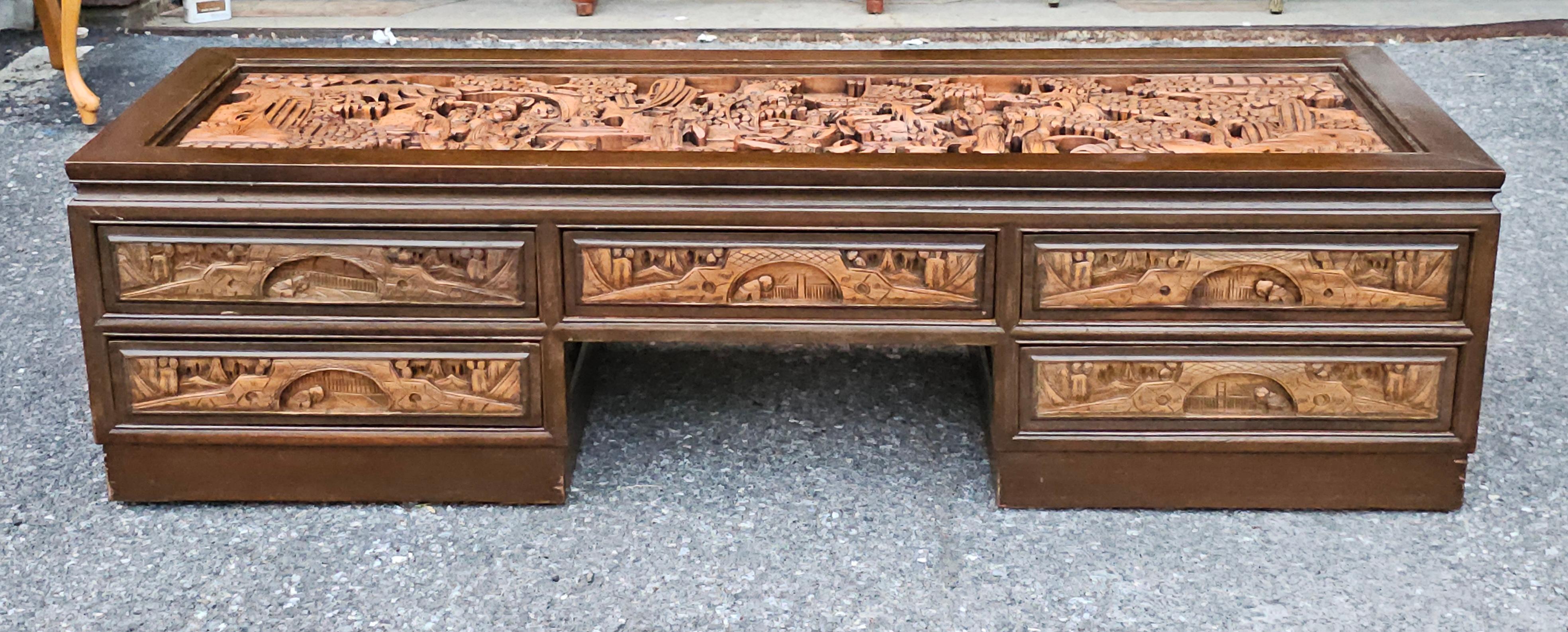 A intricately Hand-Carved Five-Drawer South East Asian Coffee Table with Glass Top Inset. Features 5 drawers flawlessly opening and closing on both front and back of the table. Dovetail drawers with  sleek, built-in handles.
Measures 60