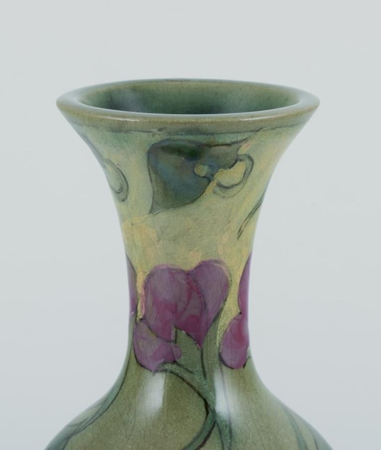 Südholland, Gouda. 
Antike und einzigartige Vase im Jugendstil aus glasierter Keramik mit handgemalten Blumen. 
Polychrome Glasur.
Um 1900.
In perfektem Zustand, mit natürlichen Rissen.
Markiert.
Abmessungen: H 26,5 cm. x T 8,0 cm.