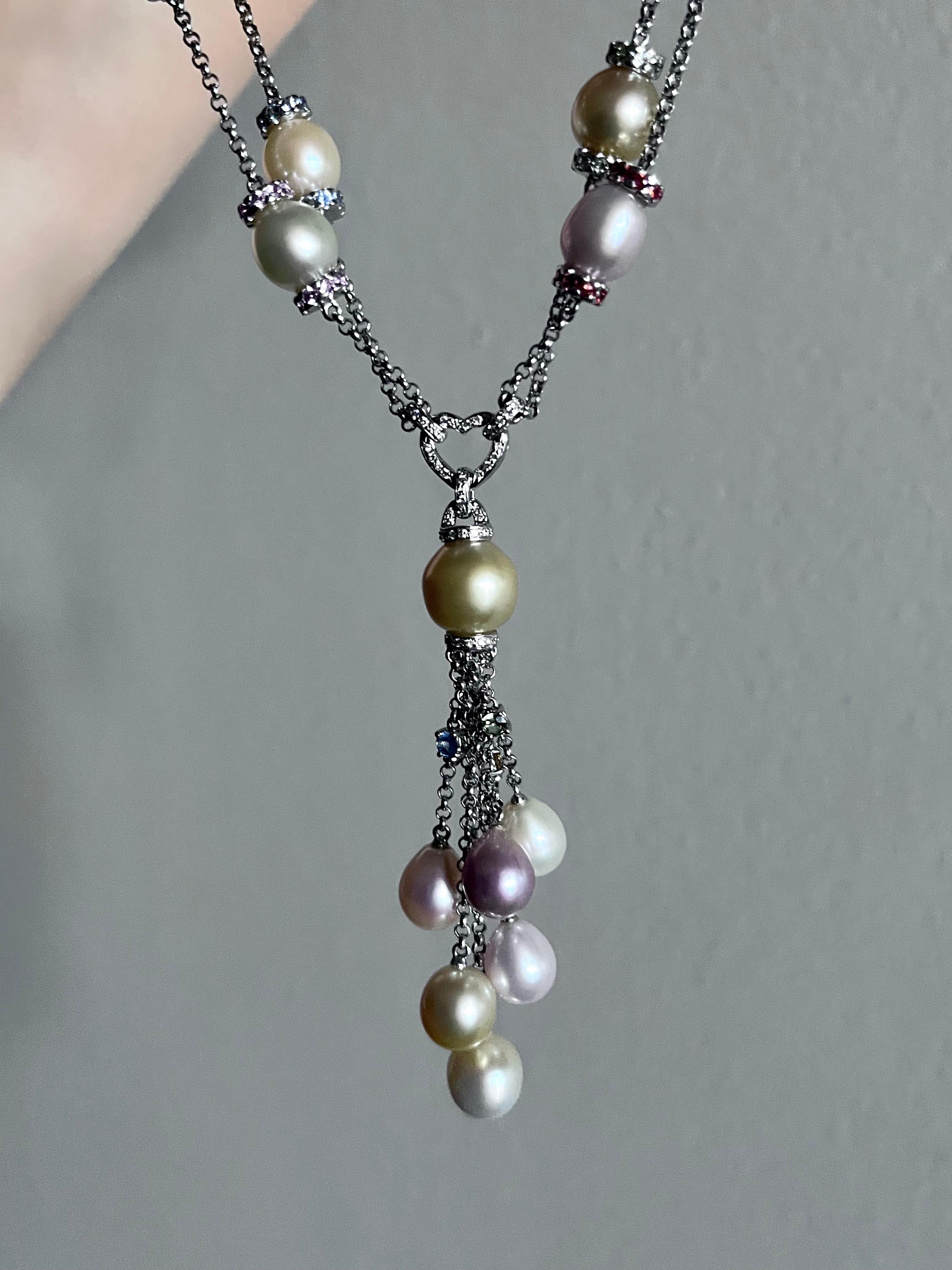 Elegant and playful, this lariat-style necklace features a stunning mix of golden South Sea pearls, soft pink and white freshwater pearls, and dazzling multi-colored sapphires and diamonds. A true statement piece that effortlessly combines