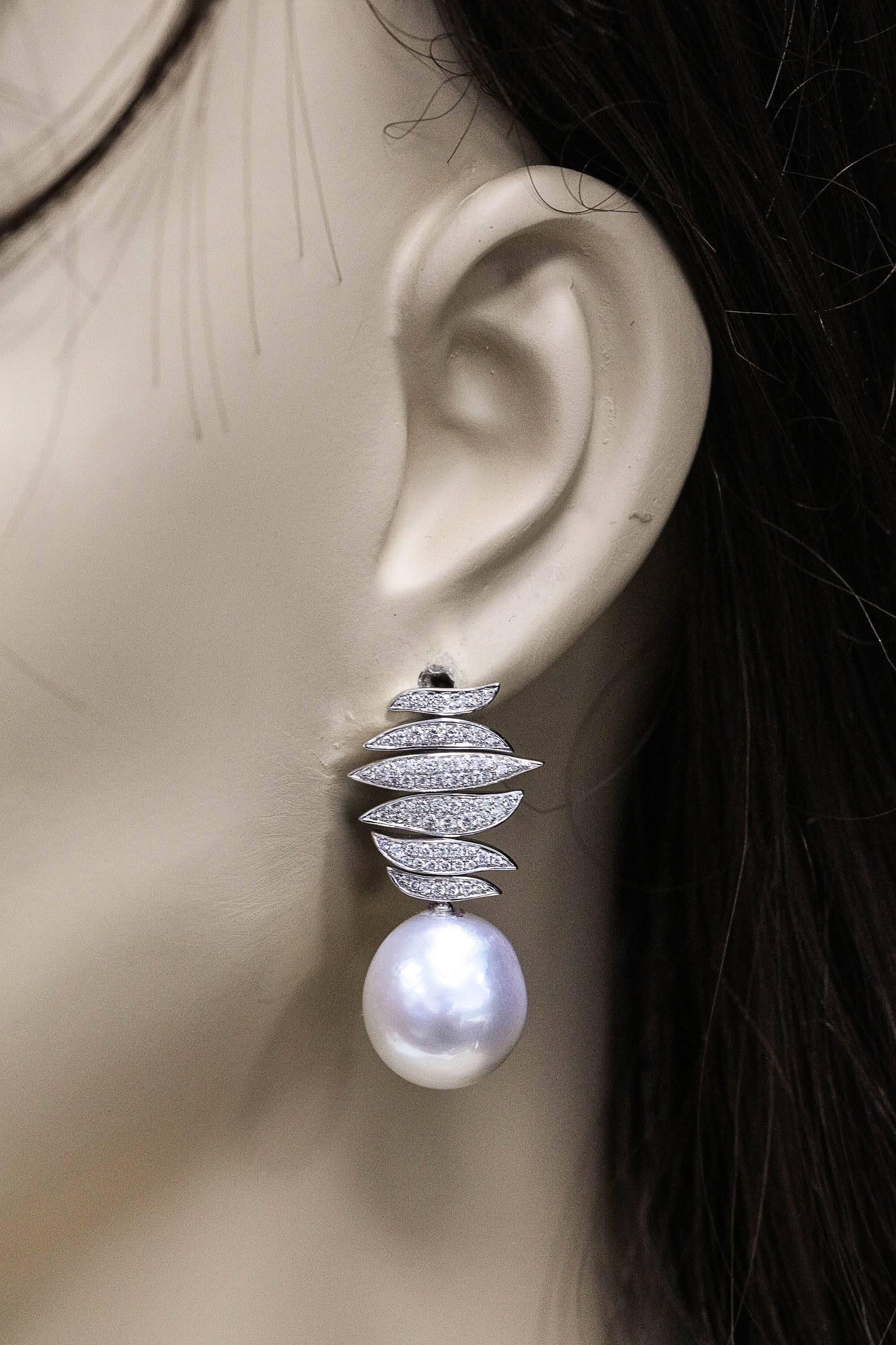18K White gold earring featuring two South Sea Baroque Pearls measuring 14-15 mm with a diamond petal design weighing 0.96 carats. Color H Clarity SI 