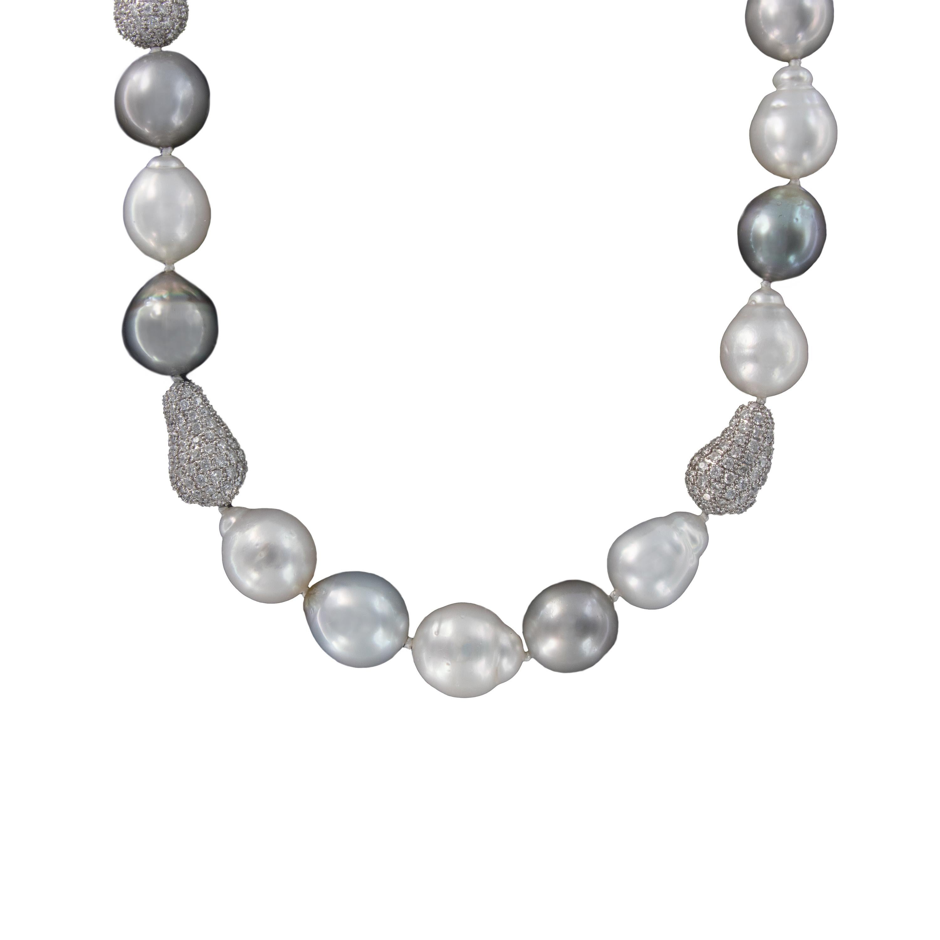 Necklace is comprised of beautifully iridescent white and silver South Sea Baroque pearls with diamond bean enhancers. 18.5 inches in length. Weighs 101.1 grams.

