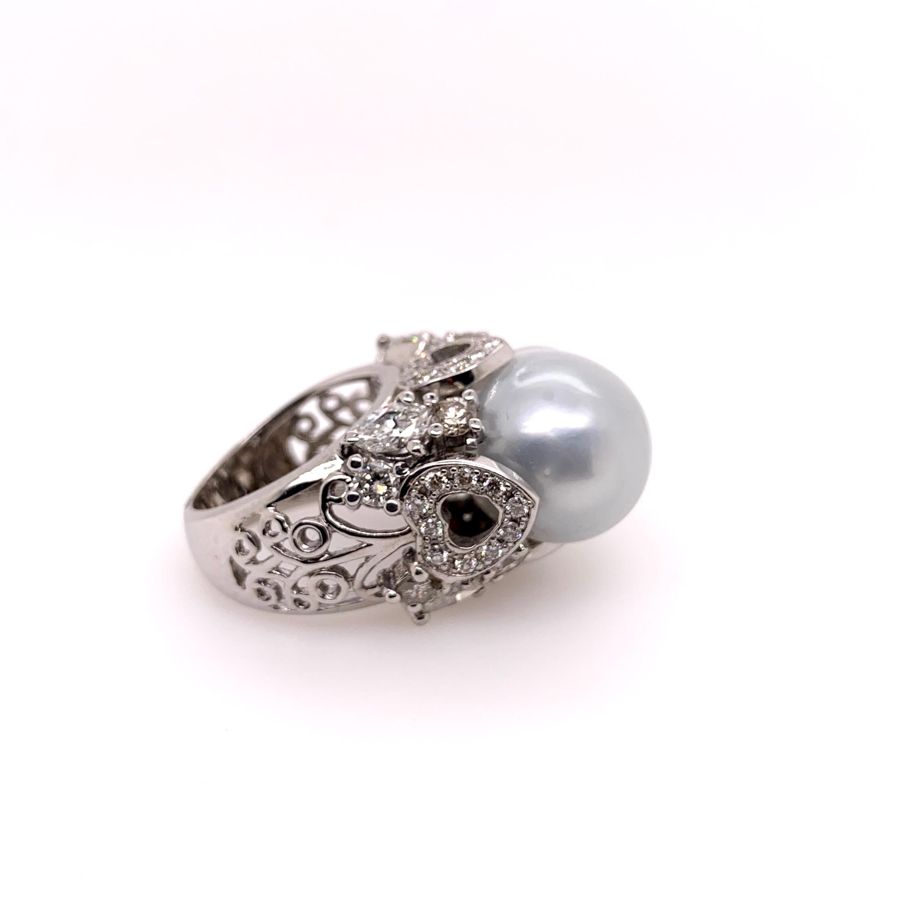 This south sea baroque pearl has a beautiful silver luster tone that accentuates this giant size pearl.  The 14k white gold setting has a high profile that accentuates the different diamond shapes and grasps the large pearl.  The diamonds come to