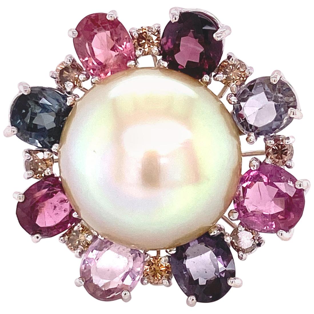South Sea Golden Pearl, Burmese Multicoloured Spinel, and Brown Diamond Gold Ring:

A beautiful and elegant ring, it features a large and rare golden South Sea pearl in the centre, with a halo of natural no heat Burmese multi-coloured spinels and