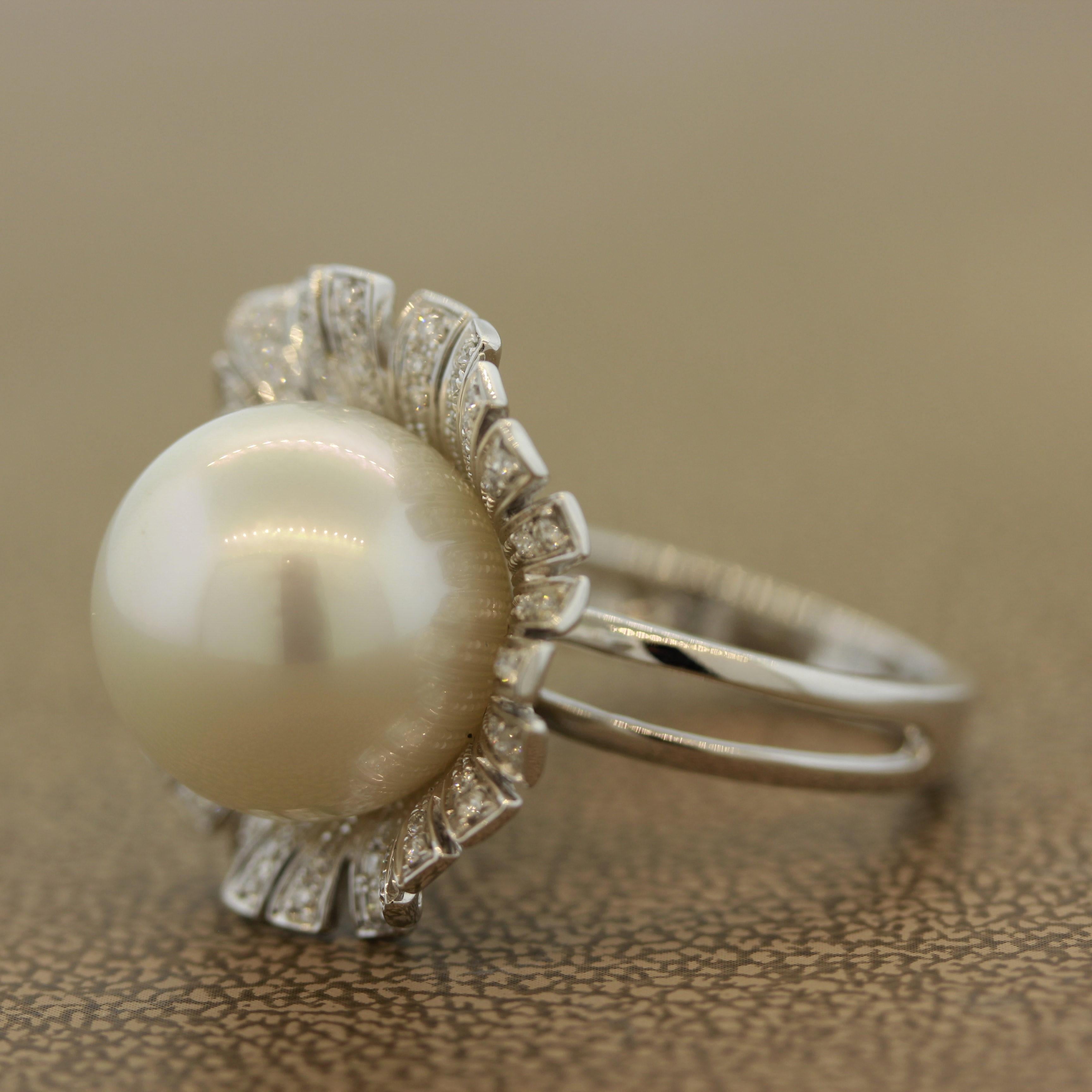 A lustrous and natural cultured South Sea pearl takes center stage as a blossoming flower-bud in this unique ring. It measures approximately 14mm in diameter and is perfectly smooth without any blemishes or bruises. It has a soft rose overtone