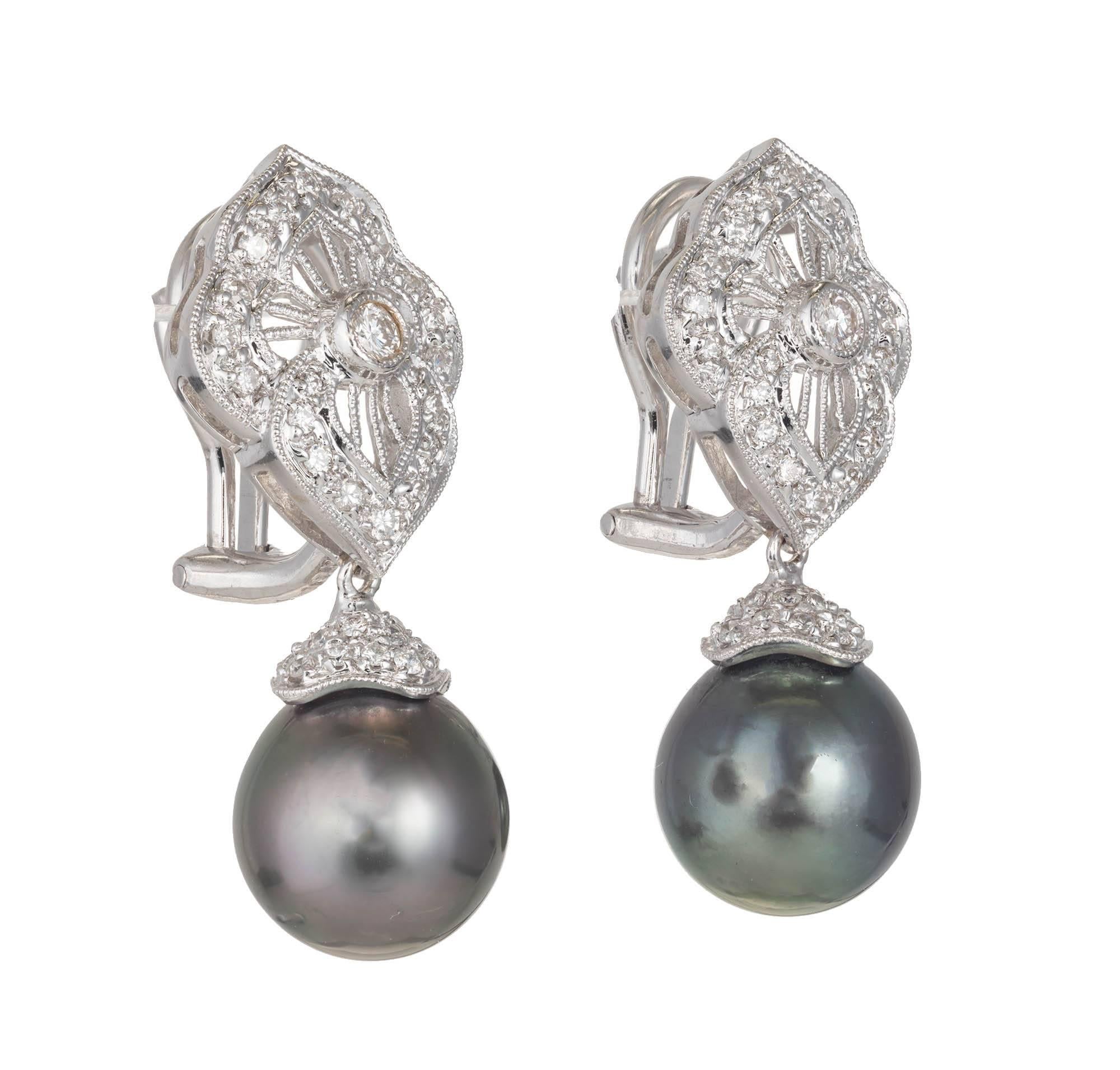 Black South Sea and diamond dangles earrings. 18k white gold with . Beautiful white sparkly diamonds, Clip post style.

2 round diamonds, .05ct each, approx. total weight .10cts
2 South Sea black pearls, 10.45mm, excellent lustre
84 round diamonds,