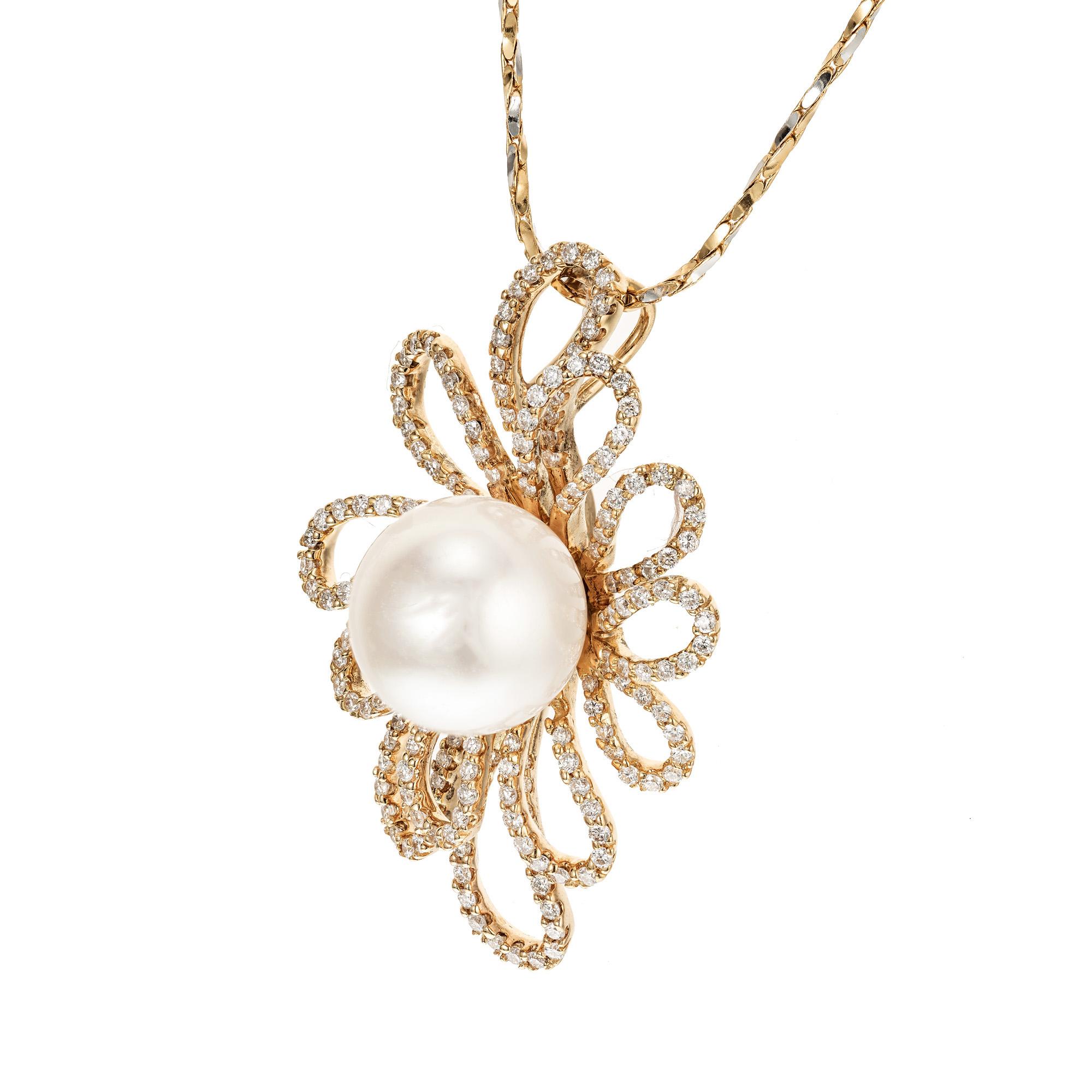 Diamond and pearl pendant necklace. 12.27mm center South Sea cultured pearl with a halo of 18k yellow gold diamond loops. 18 inch 18k yellow gold chain.

12.27mm South Sea cultured pearl AA grade, white with excellent lustre. 
Approx. 175 full cut