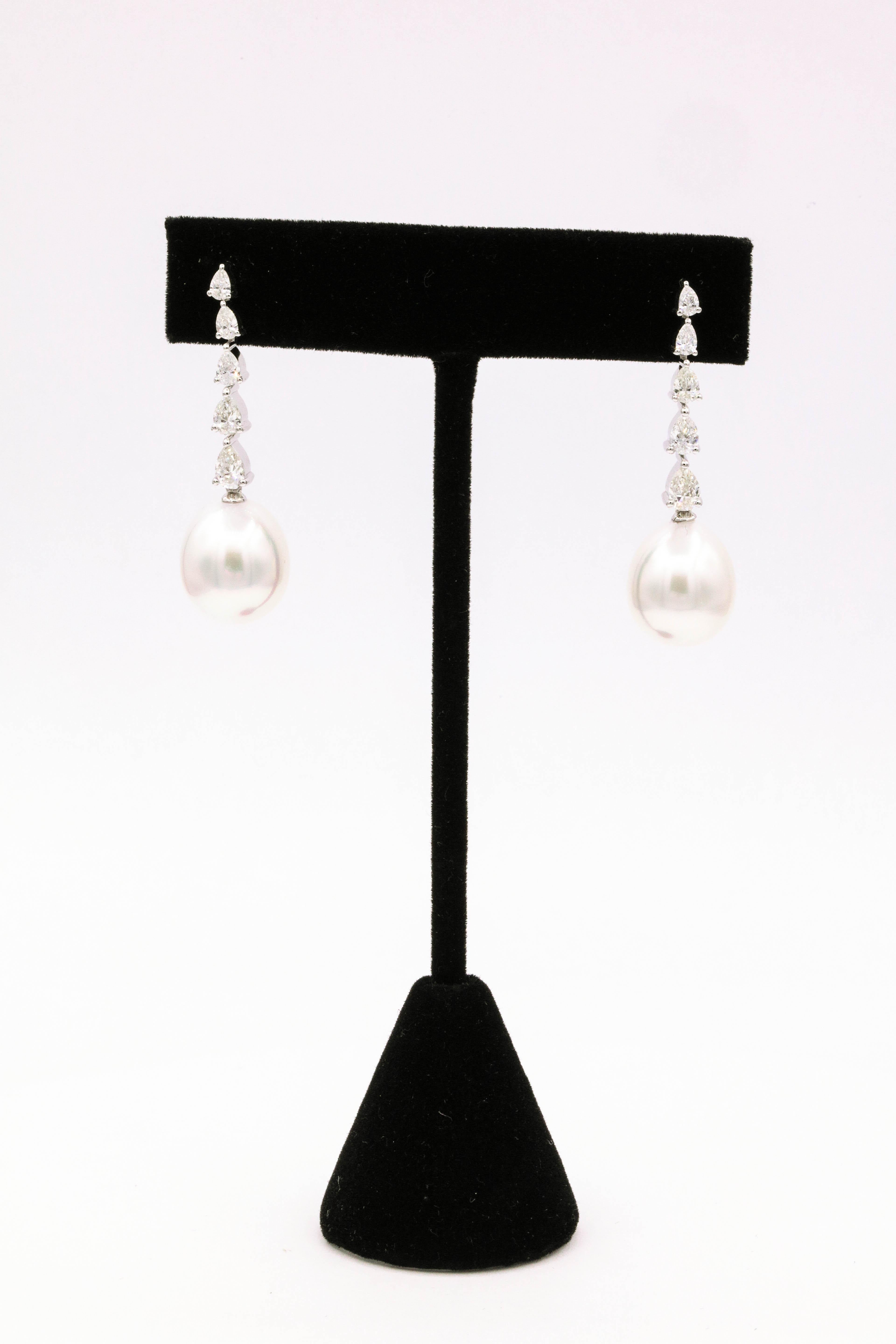 South Sea pearl drop earrings featuring 10 pear shape diamonds weighing 1.40 carats, in 18k white gold. 
South Sea Pearls: 12-13 mm
Color: G-H
Clarity: SI