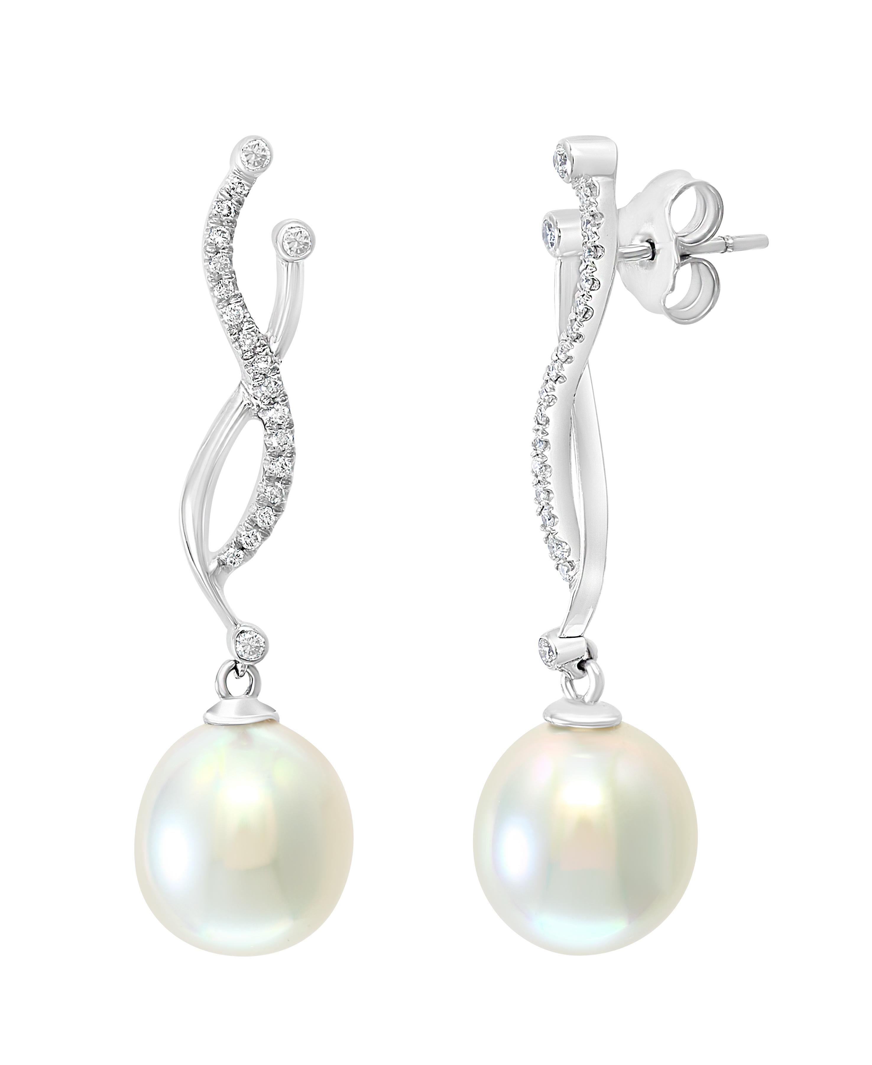 These elegant Diamond and Pearl earrings feature South Sea drop cultured pearls dangling gracefully from a white gold and diamond setting. 
- 14K White Gold.
- 0.27 Carats of Diamonds. 
- Pearls measure 11.2x12.1mm
