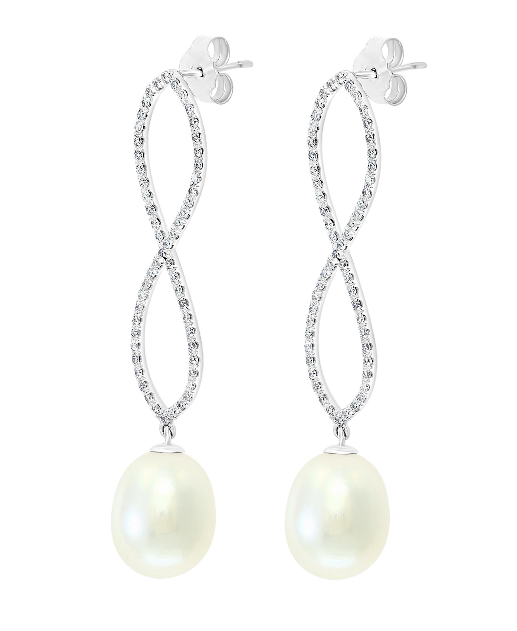 These elegant Diamond and Pearl earrings feature South Sea drop cultured pearls dangling gracefully from a white gold and diamond infinity setting. 
- 14K White Gold.
- 0.84 Carats of Diamonds. 
- Pearls measure 11.6x13.9mm