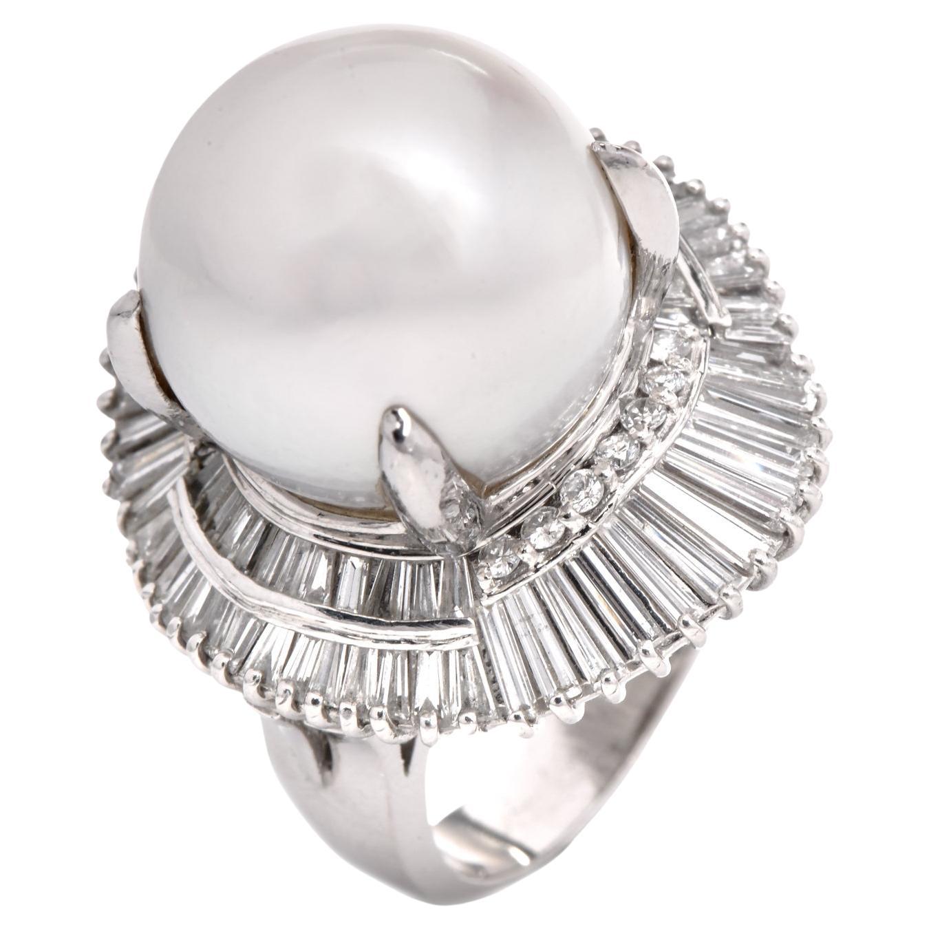 This impressive ballerina ring is crafted in solid platinum, weighing 25.7 grams and measuring 21mm wide and 19mm high. This alluring cocktail ring is centered with a lustrous south-sea pearl of cream-white color, measuring 15mm in diameter,
