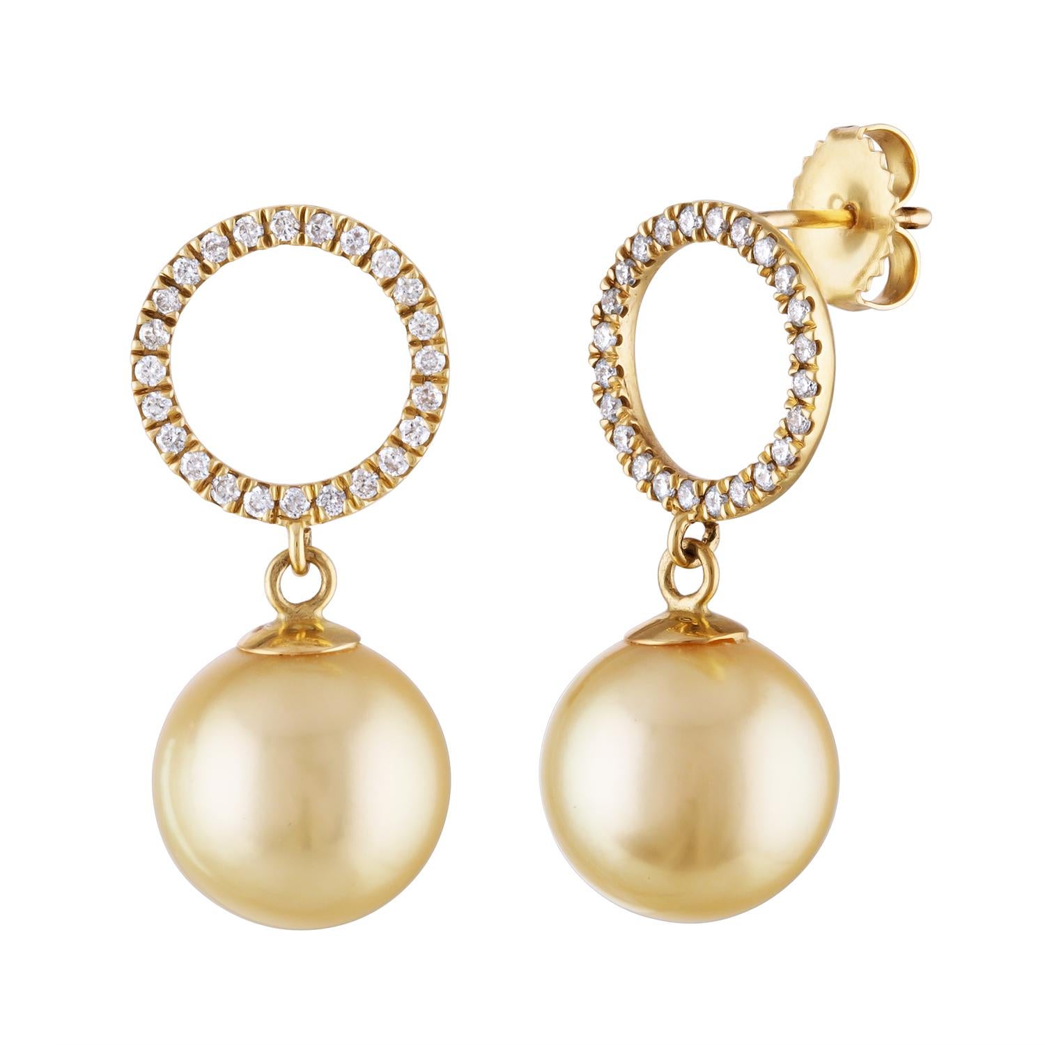 These earrings feature South Sea natural-color golden cultured pearls dangling from a 14 karat yellow gold and diamond halos. These fine quality perfectly round pearls measure 11.8mm. The halos consist of 0.36 carats of diamonds. The earrings are