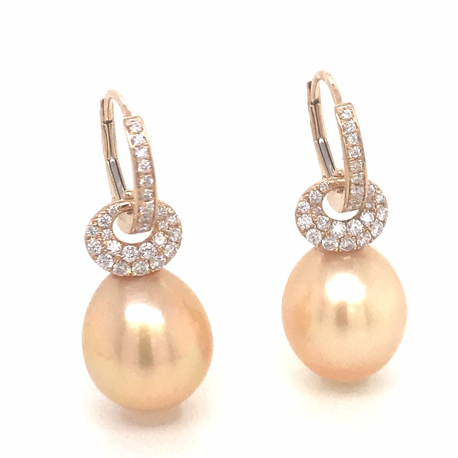 18K Yellow gold drop earrings featuring two Golden South Sea Pearls measuring 12-13 mm with 56 round brilliants 0.57 carats.
Color G-H
Clarity SI

Pearls can be changed to Tahitian, Pink or White Pearls upon request. 

Diamond Height: 11/16