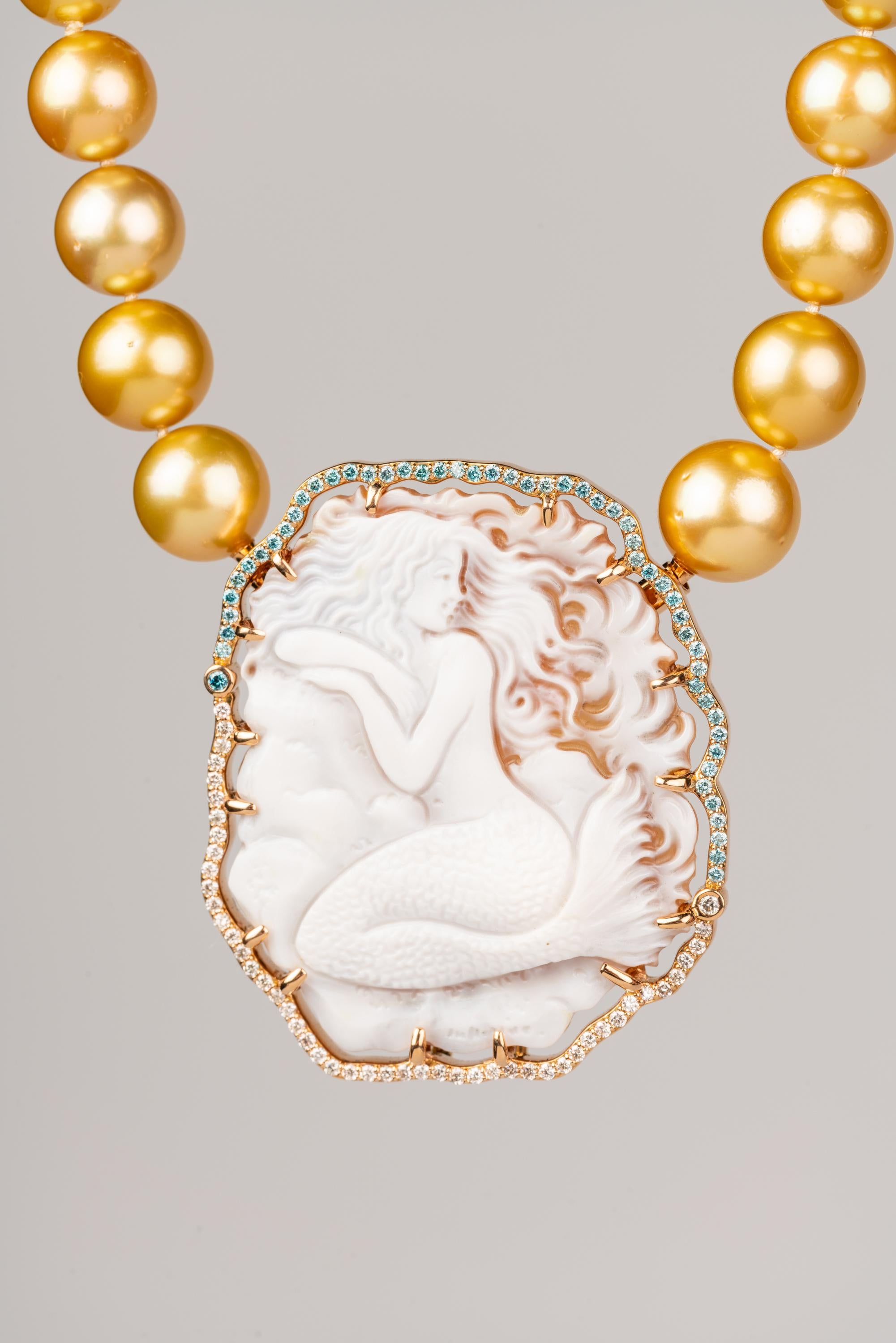 An 18k rose gold clasp and brooch prong set with an Italian carved agate mermaid cameo with one 2mm and fifty one top light brown diamonds for a total of .8 carats, and one 2mm, one 1mm, and forty seven 1.5mm aqua blue diamonds for a total of .73
