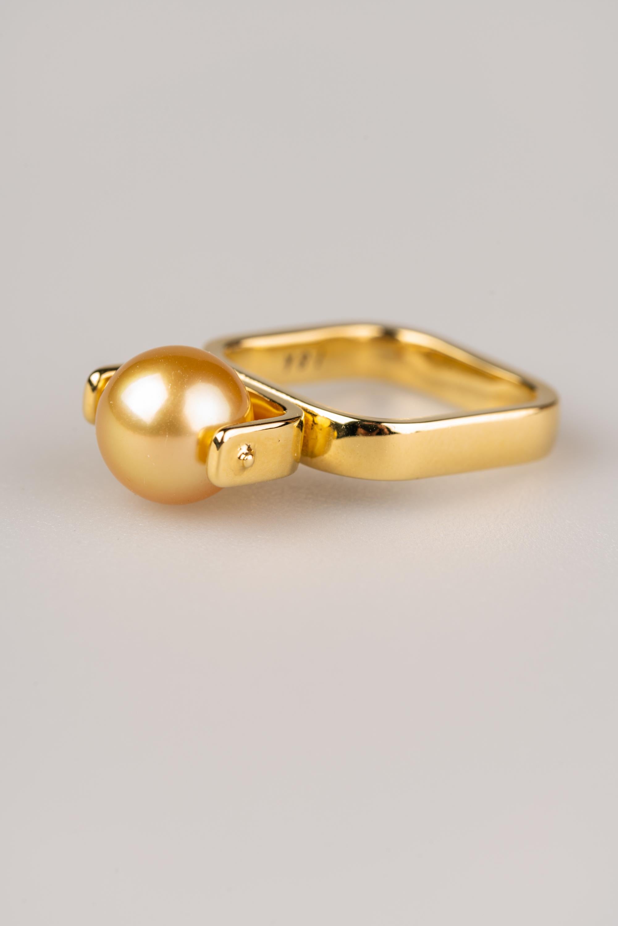 An 18k yellow gold ring with one 9mm South Sea Golden pearl. Ring size 7. This ring was made and designed by llyn strong.