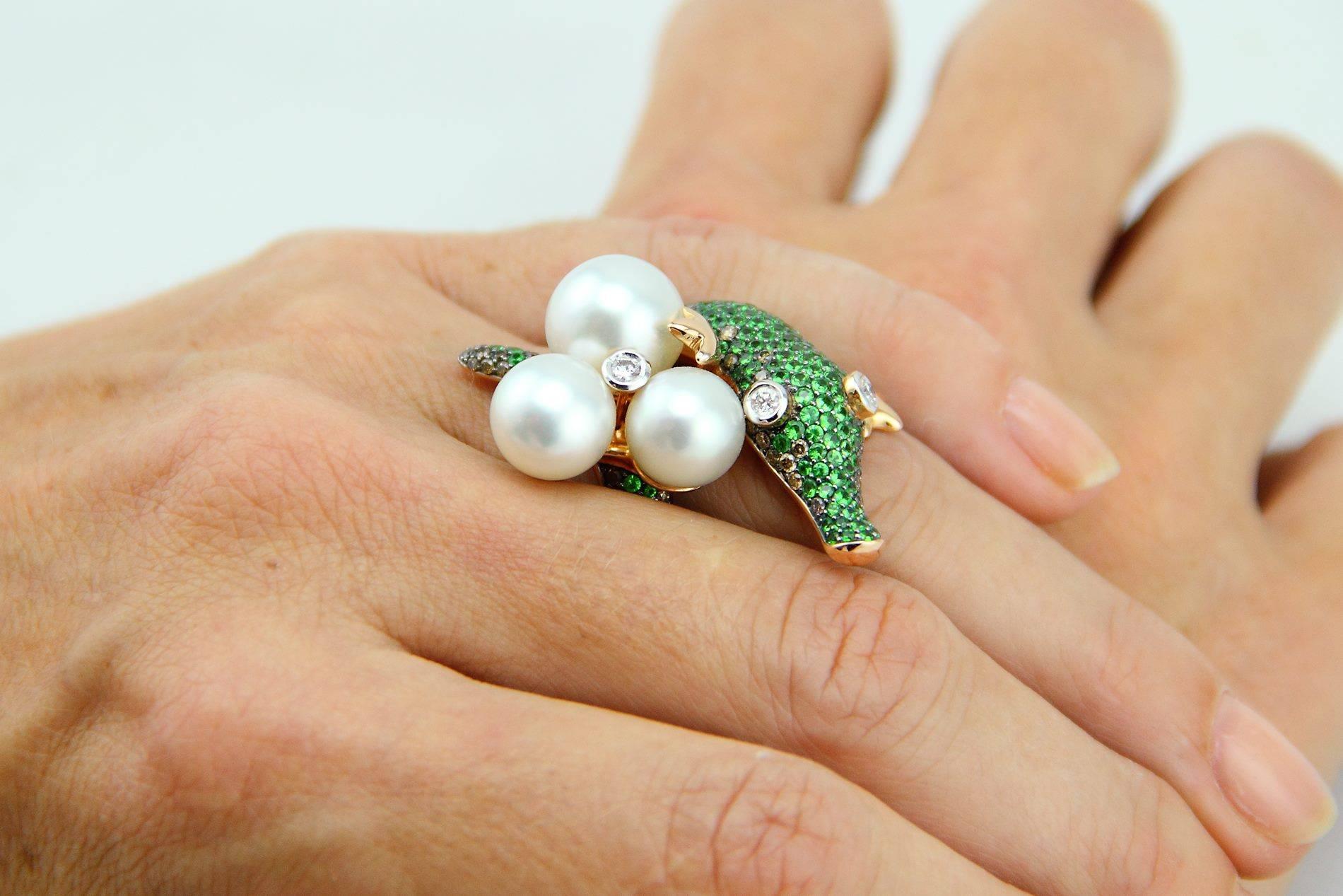 This delightful crocodile cocktail ring is crafted using beautiful unblemished Australian South Sea Pearls, set with carefully selected clean cut green tsavorites, brown and white diamonds.  Top quality manufacturing, set in rose gold 18K.  The