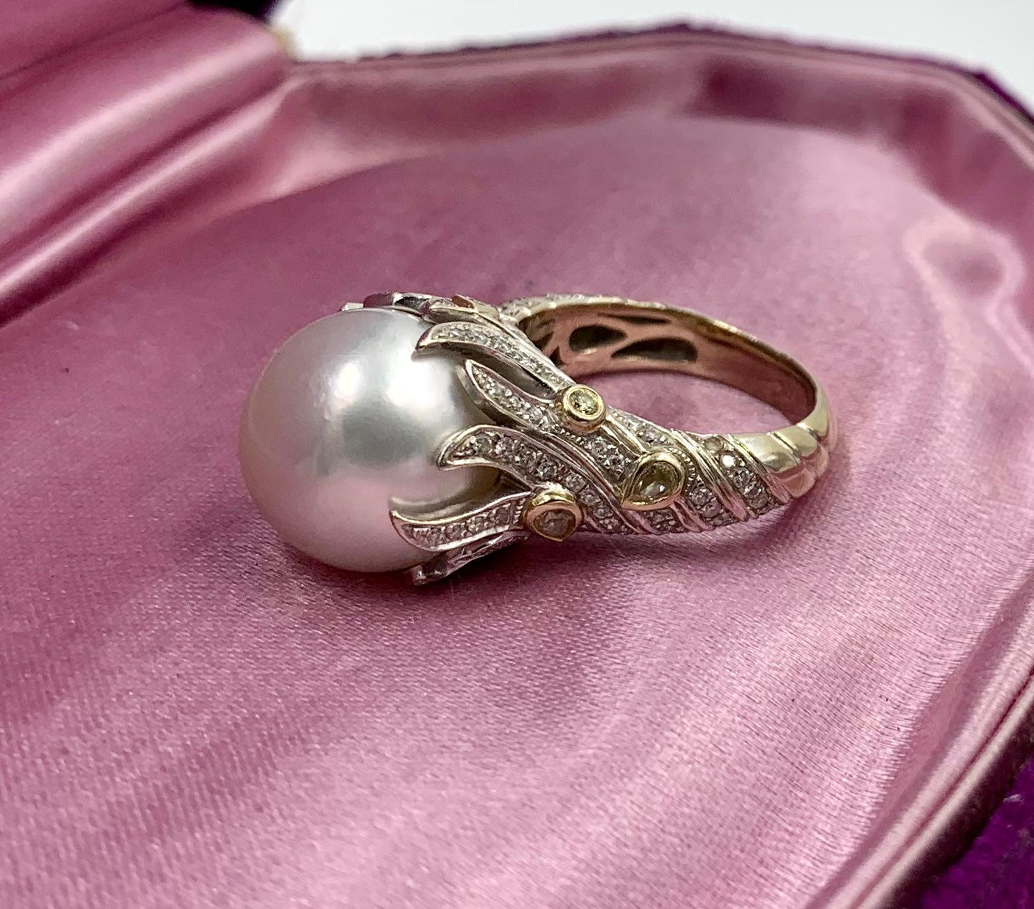 A magnificent South Sea Pearl Ring set with eight Fancy Yellow Diamonds and 122 Round Brilliant Cut Diamonds in a wonderful flame motif setting in 18 Karat Yellow and White Gold.   The extraordinary South Sea Pearl is 13.5mm in diameter.  It has a