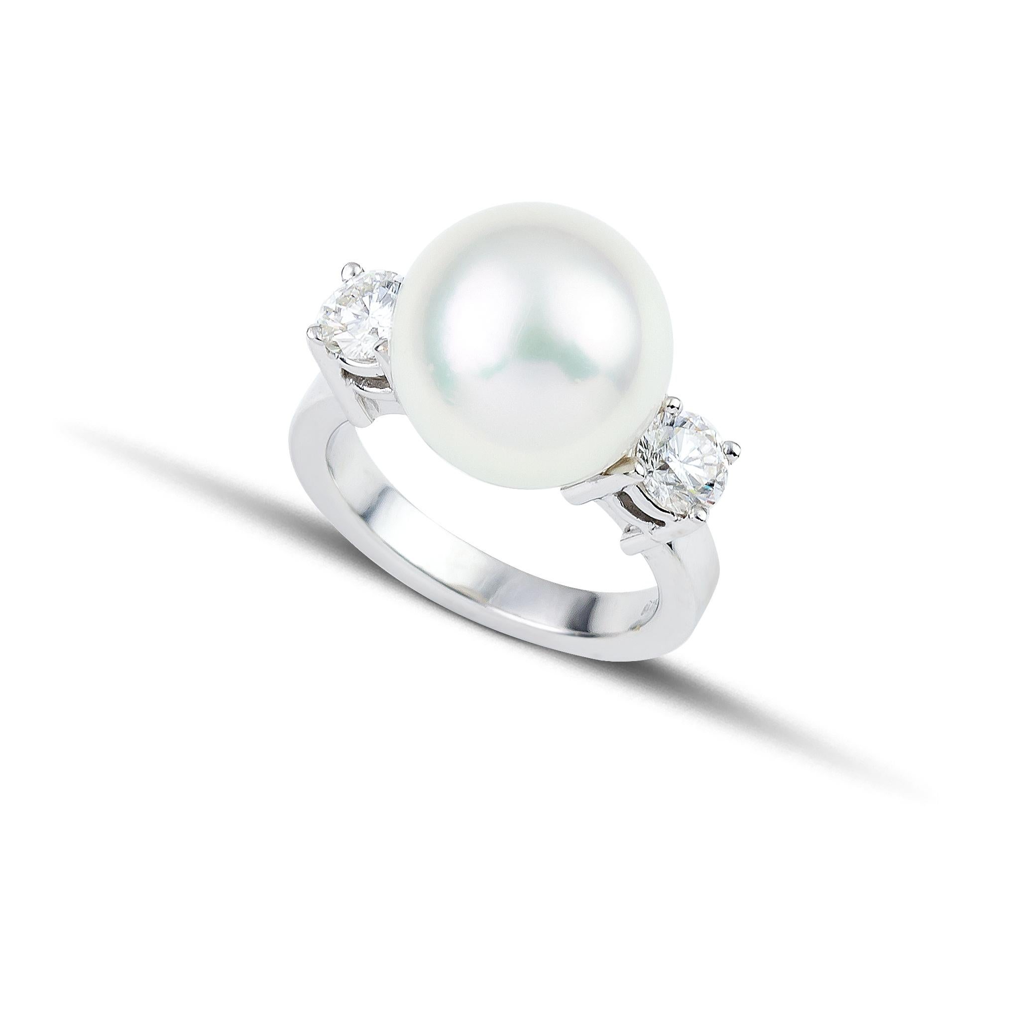 South sea 13mm white pearl ring between two brilliant cut diamonds, handcrafted in 18Kt white gold. The diamonds that are set carefully among four prongs reflect the light and illuminate this elegant South Sea Pearl. This delicate jewelry piece