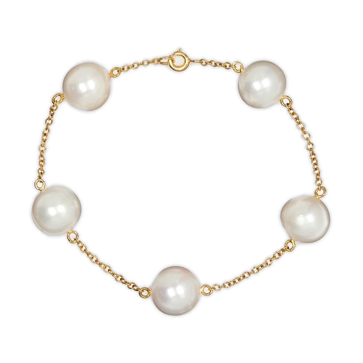 White South Sea Pearl 18K Yellow Gold Chain Bracelet by Water Jewels. Handmade with an 18K Yellow Gold chain strung with 5 White round South Sea Pearls. Each Pearl has been selected  for its luster, shape and colour. All 5 Pearls are an excellent