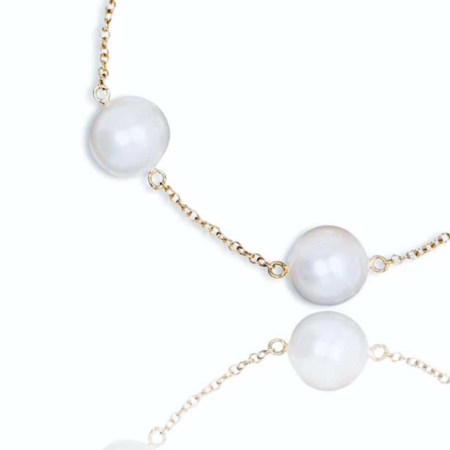 White South Sea Pearl 18K Yellow Gold Necklace by Water Jewels. Handmade with an 18K Yellow Gold chain strung with 12 White round South Sea Pearls. Each Pearl has been selected  for its luster, shape and colour. All 12 Pearls are an excellent match.