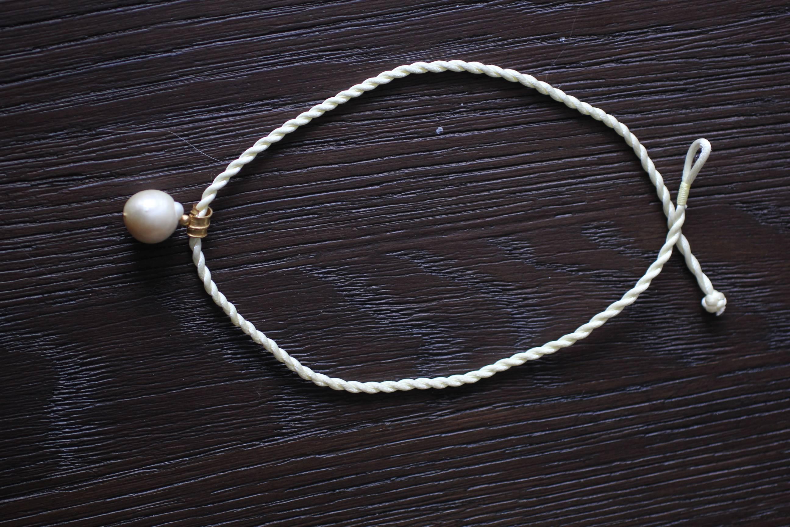 In The Sea South Sea pendant. Made to order, custom made hand formed chocker pendant. White Baroque South Sea pearl hangs off of organically shaped bail hand forged of 21K gold. No two necklaces are identical. 

The inspiration for this pendant