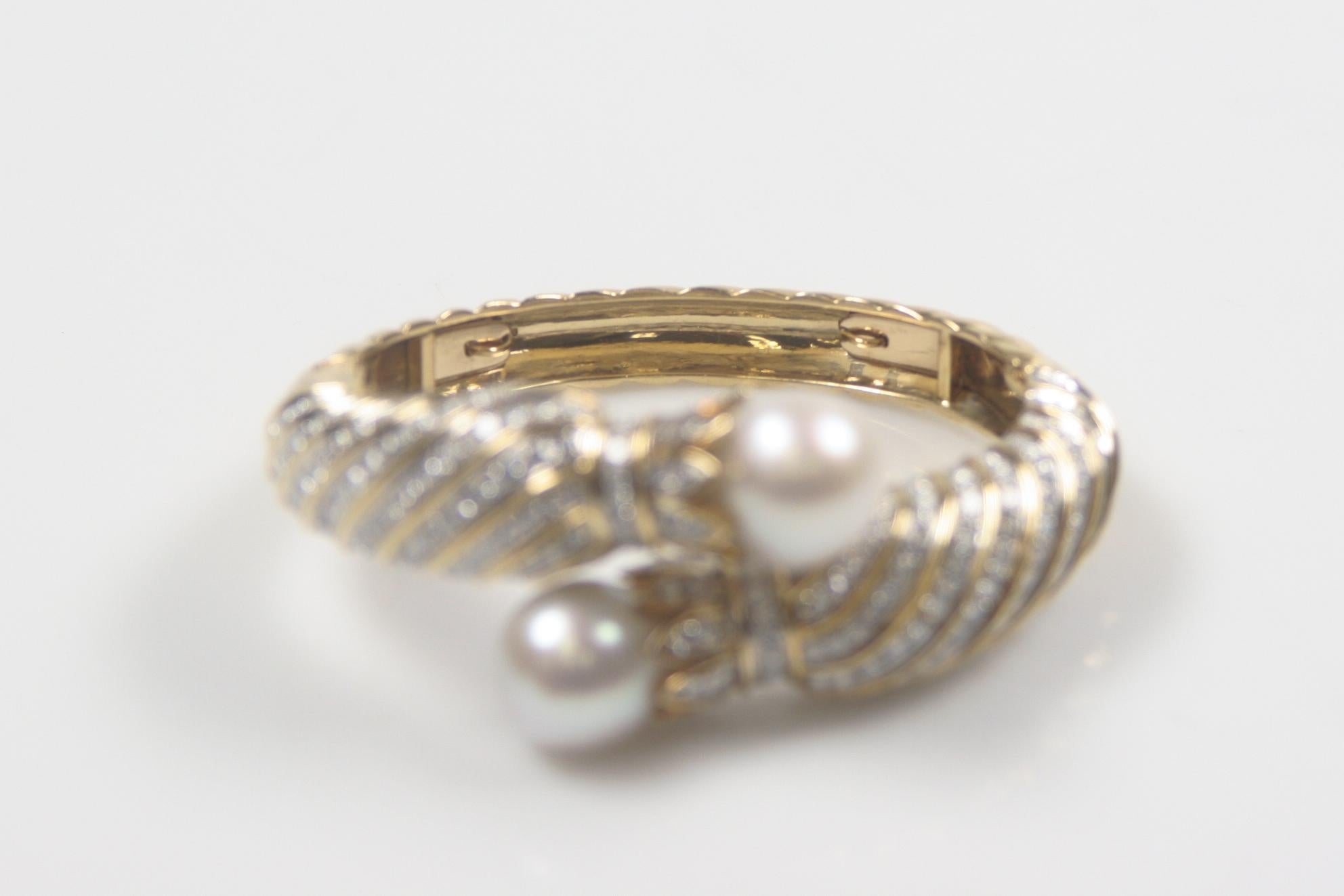 Gorgeous Double-Hinged 18k Yellow Gold Diamond & South Sea Pearl Bangle
Features 248 Round Brilliant Pavé-Set Diamonds in Spiral Pattern
Total Diamond Weight = 10.00 carats
Average Clarity = VS
Average Color = G - H
Culminates in two South Sea