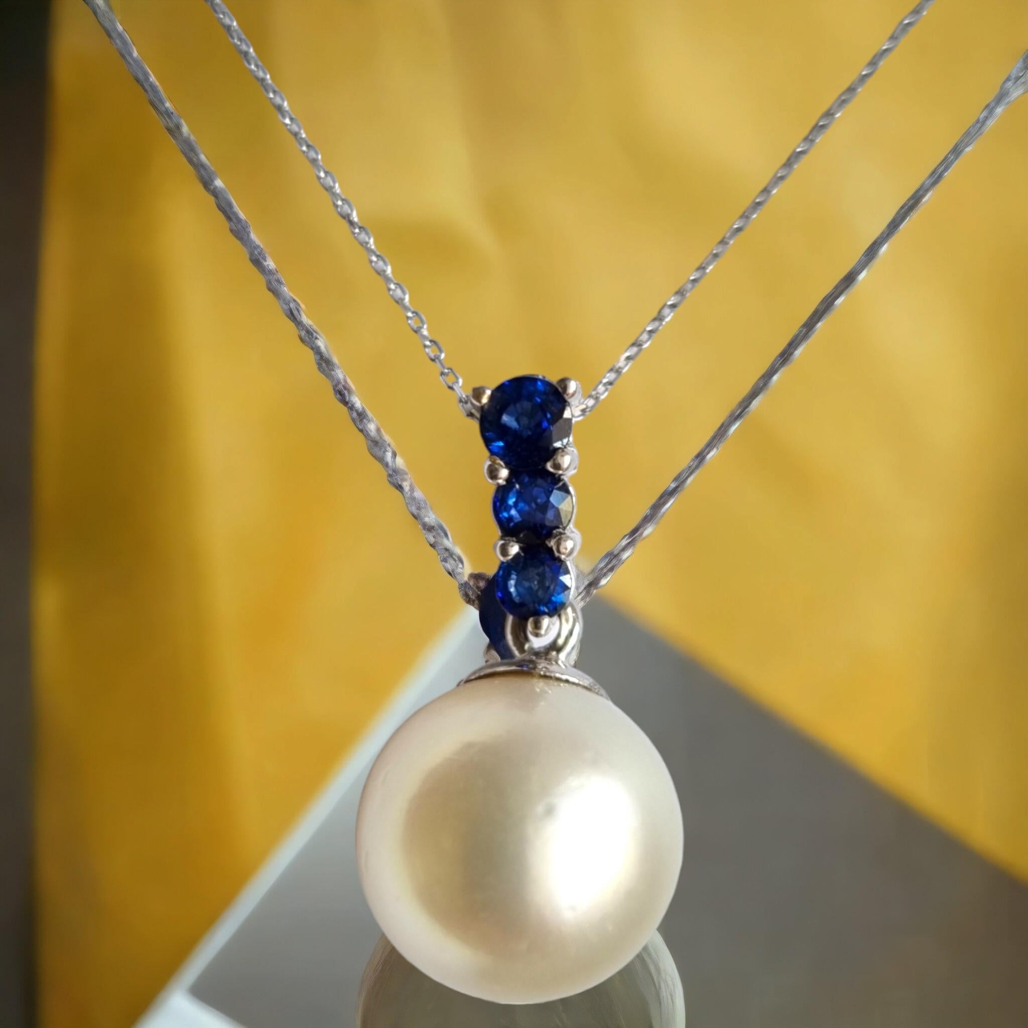 GIA Certified South Sea Pearl and Blue Sapphire Pendant.
South Sea Pearl diameter 14mm, weighing 19,51 carats. GIA report number  6162646020 4-1 engraved. Pearl characteristics: round shape, white color, bead cultured saltwater pearl with a good