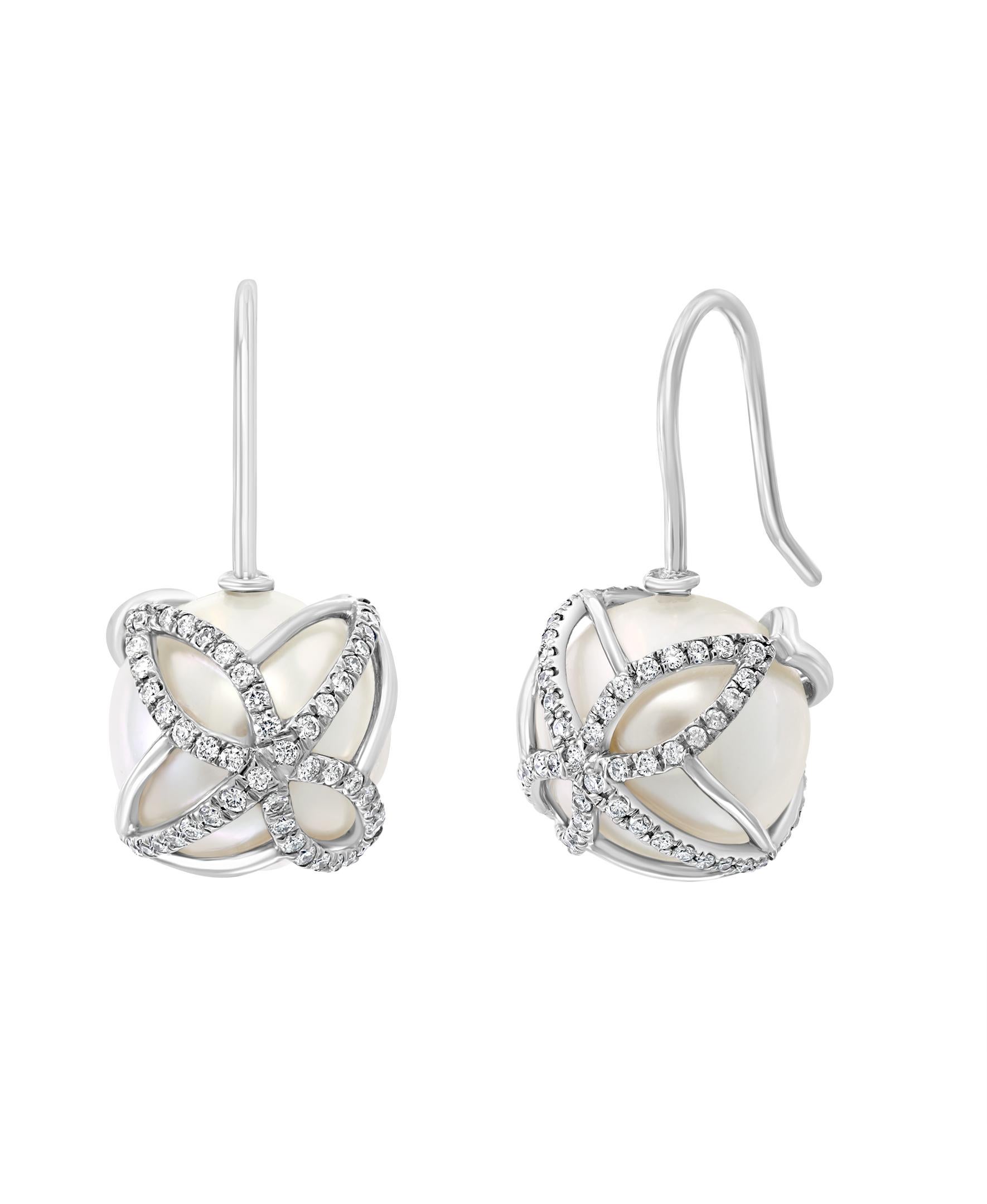 These elegant Diamond and Pearl earrings contain South Sea white round cultured pearls gracefully encased in white gold and diamonds. The butterfly design creates a striking enclosure for these lustrous pearls.
- 14K White Gold
- 0.54 carats of