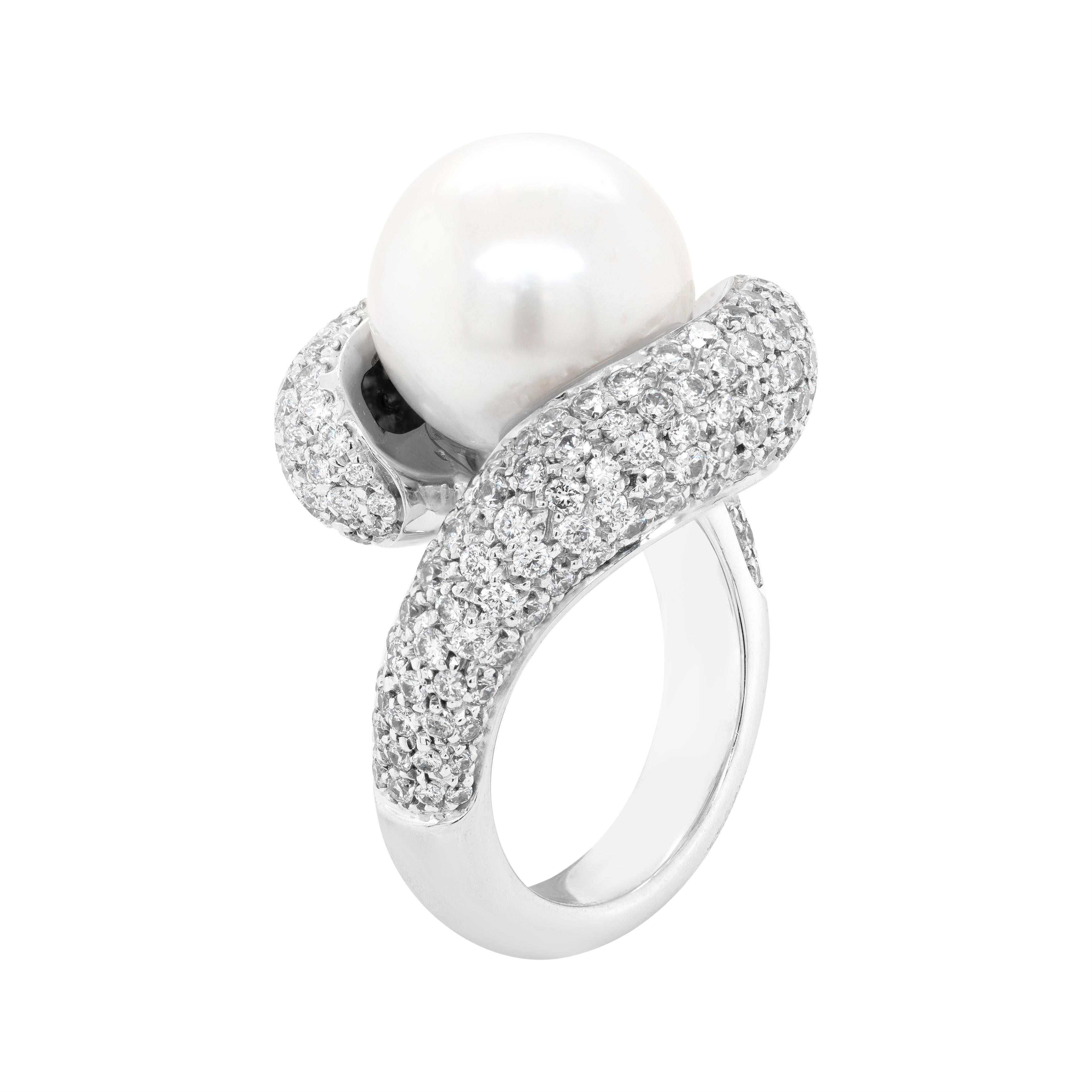 This sophisticated cocktail ring features a gorgeous  12mm white South Sea pearl in the centre of a twist cross-over mount, pavè set with round brilliant cut diamonds with an approximate total weight of 3.00 carats. The band graduates from 7.3mm to