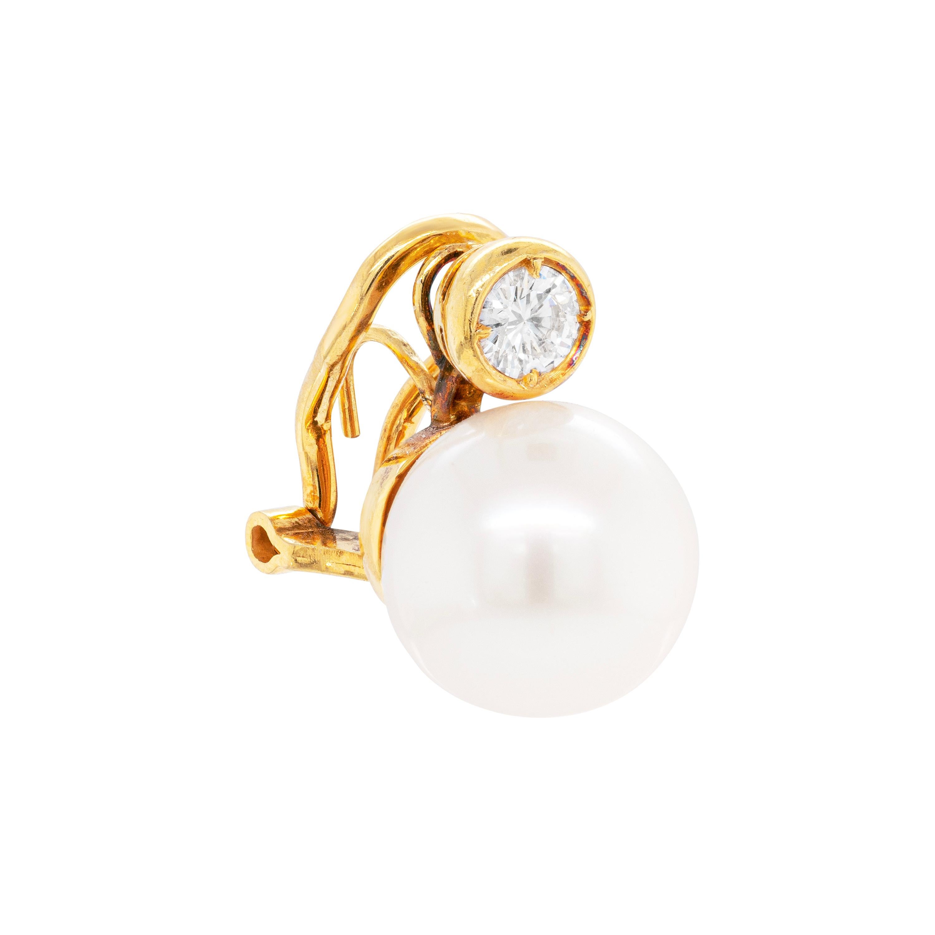 Beautifully elegant dress earrings featuring a cultured white South Sea pearl approximately measuring 11.5mm in diameter accompanied by a fine quality round brilliant cut diamond on top weighing approximately 0.30ct each in 18ct gold rub-over