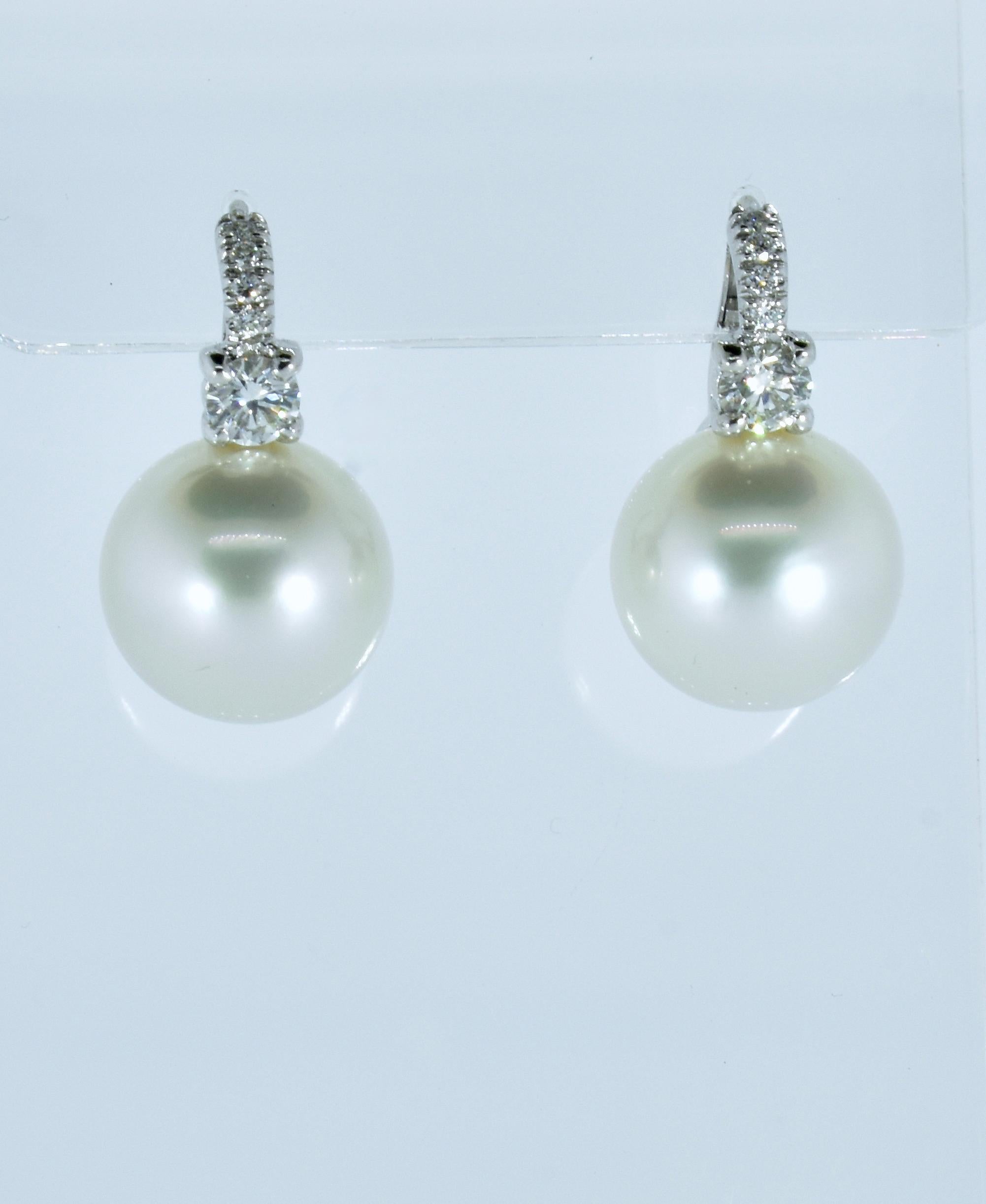 Luxuriate in the knowledge that these are perfectly spherical, blemish free, high luster, deep -nacred silver white south sea pearl well identically matched specimen south sea pearls.  Topped with 0.68 cts. Of H, VS1 (near colorless and very