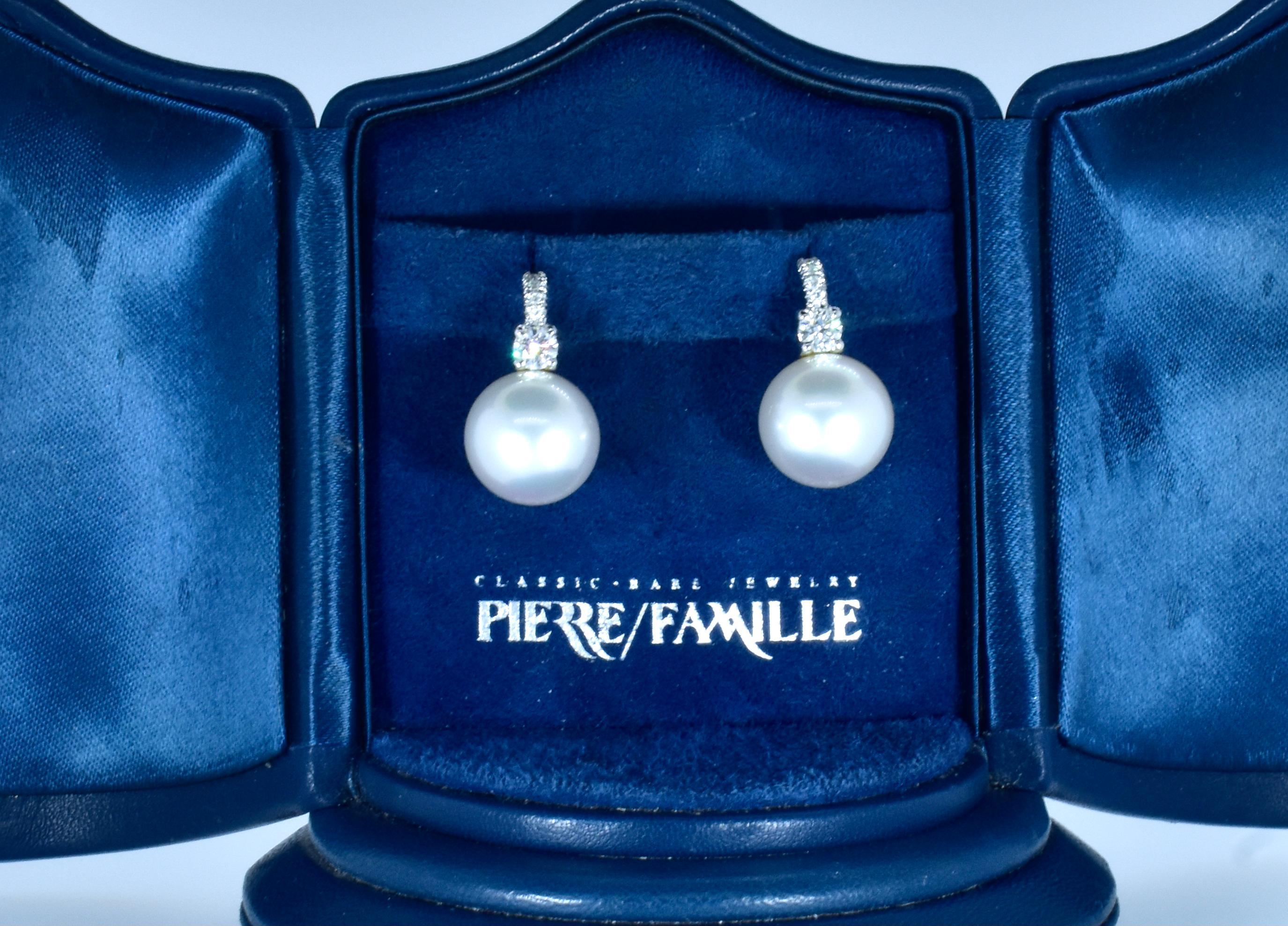 Large and fine white South Sea pearl and diamond earrings. Luxuriate in the knowledge that these are perfectly spherical, blemish free, high luster, deep -nacred silver white south sea pearl well identically matched specimen south sea pearls. Topped