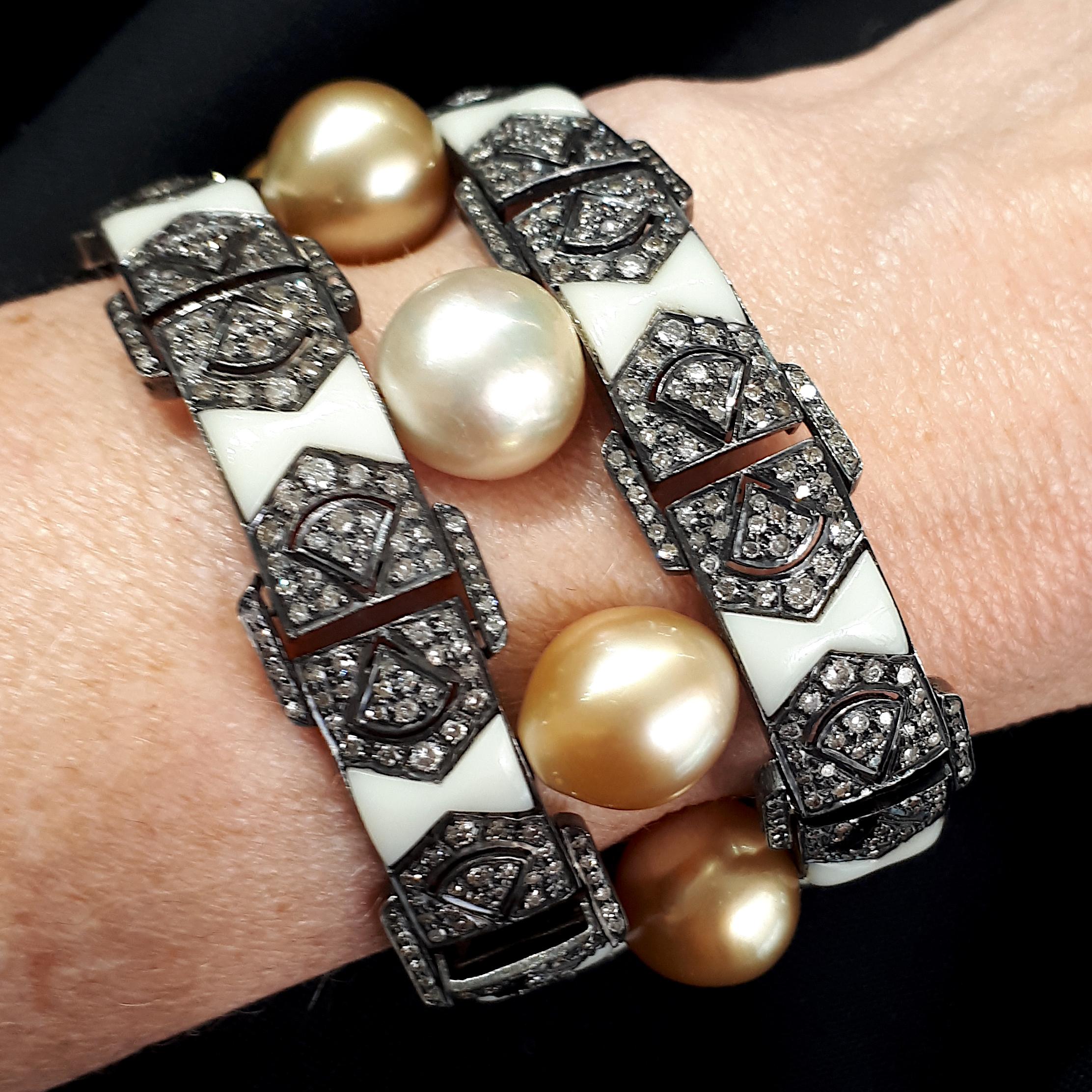 A Bakelite Bracelet, comprising of two outer rows of white Bakelite, with gold coloured South Sea pearls set in-between, and eight-cut diamonds set either side, mounted in silver and gold. With two tongue fittings, and figure-of-eight safety catches.