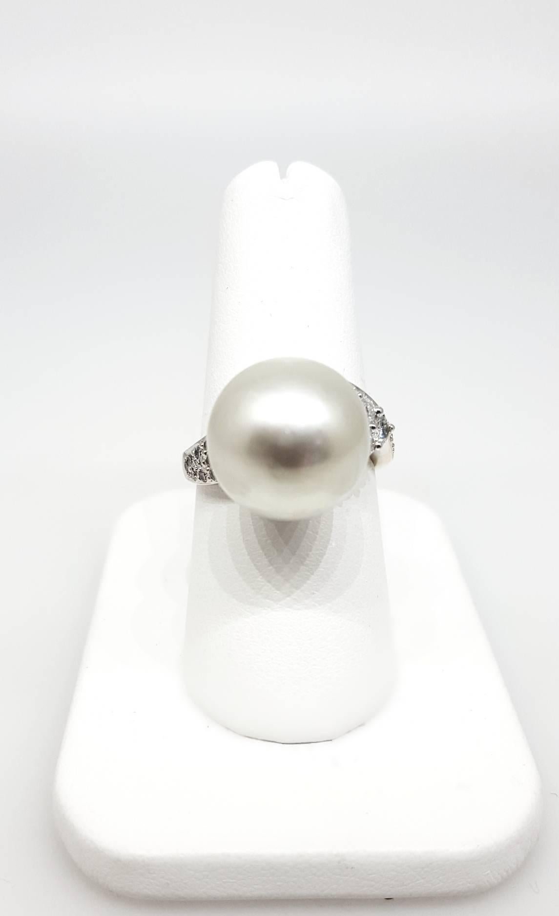 An 18 karat white gold ring set with a south sea pearl that measures 13.68mm. The diamonds are H to I color SI2 clarity and weigh approximately 0.33cttw. The ring is a size 7. 

South Sea Pearl and Diamond Cocktail Ring